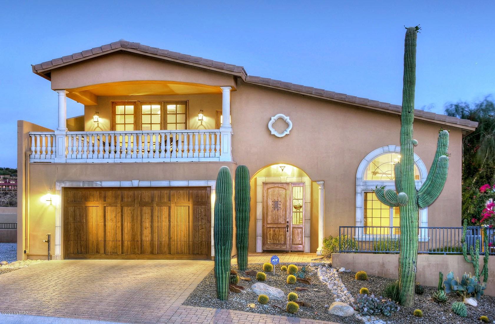 This elegantly appointed townhome w/superb city & mountain views is sure to please the most discerning buyer! Located in the gated community of Sin Vacas, this home offers an open floorplan, upgraded kitchen w/SS appliances, granite counters, alder cabs & wine fridge. Greatroom boast sky-high ceilings, spacious dining area & opens to the expansive patio. Separate den/living rm w/built-ins, Downstairs master has French doors to the patio, ensuite w/dual sinks, jetted tub & walk-in shower. Upstairs you'll find 2 bdrms, w/private balconies capturing sunset, mtn & city light views, plus a full bath. Travertine tile in all the right places, alder doors & architectural details throughout. Community pool is next door! Ideal foothills location close to some of the best shopping & dining in Tucson!
