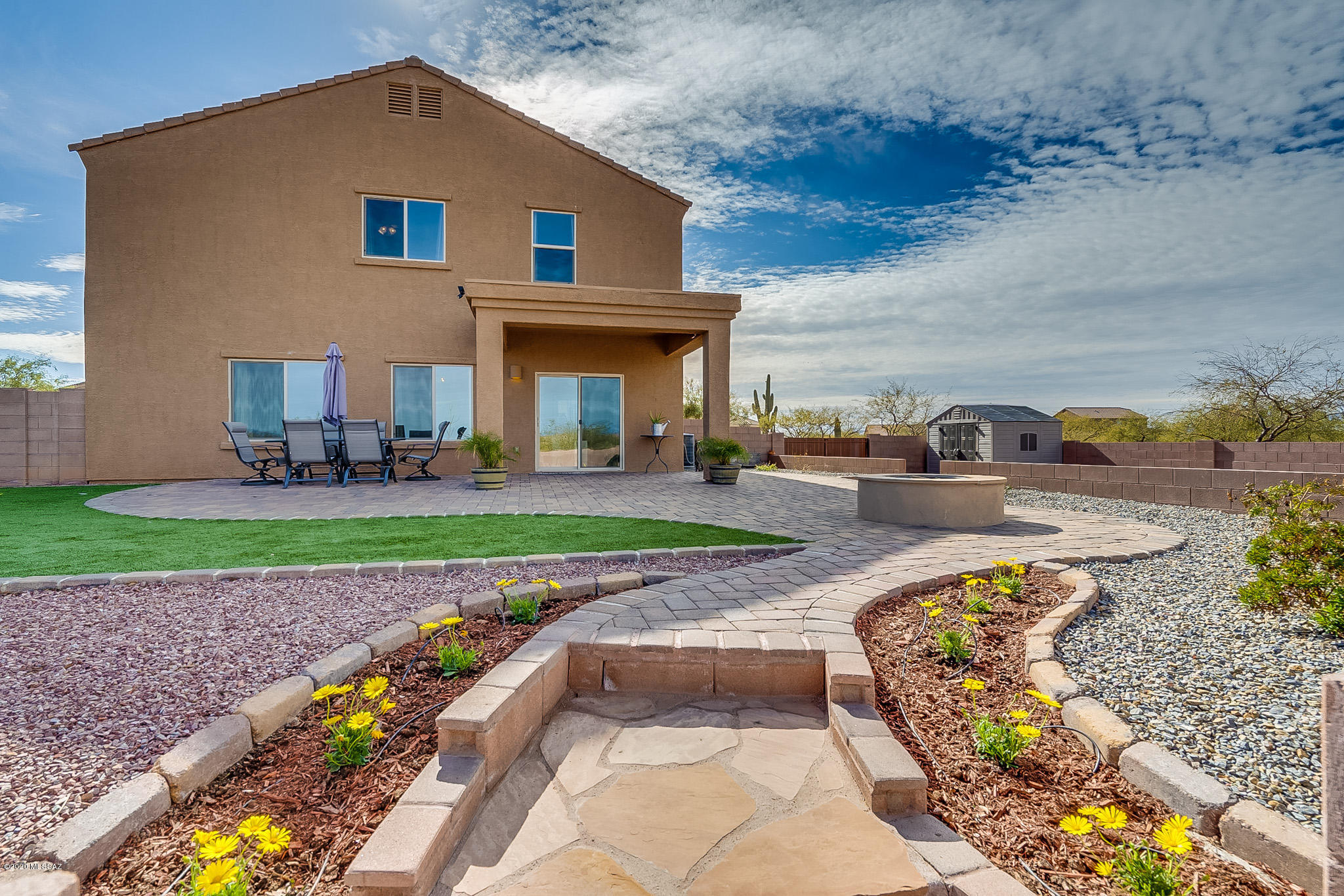 Absolutely immaculate and gorgeous home in the well desired Sahuarita Highlands Community. At 1.7 acres, it boasts one of the largest lots in the community. In the interior, the kitchen includes upgraded cabinetry with granite counter top and stainless steel appliances. The kitchen overlooks a big family room. The bottom floor has upgraded large ceramic tile throughout.  The master bedroom is huge with  incredible mountain views and a big walk-in closet.  This home is perfect for entertaining with an amazing and professionally landscaped back yard! It is fully enclosed by a block wall and has large brick patio and a built-in fire pit . It is a truly amazing home that you have to see for yourself!!
