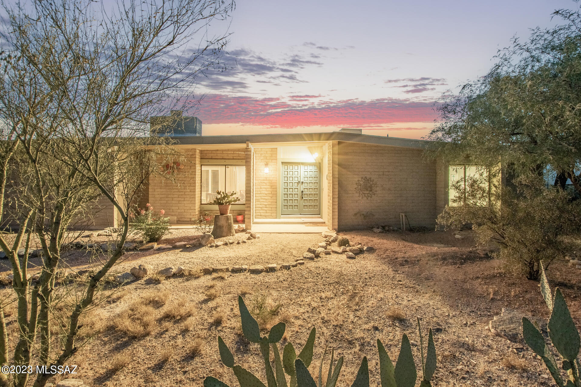 Incredible single-level home w/breathtaking mountain views is the one! Featuring a desert landscape, a cozy front porch, & a 2-car side-entry garage w/an extended driveway. Discover gorgeous wood-look tile flooring, a well-sized living room w/a wood-burning fireplace & a bright family room, both w/sliding glass doors to the patio. Impeccable eat-in kitchen includes SS appliances, recessed lighting, handsome wood cabinetry w/crown molding, granite counters, subway tile backsplash, an island w/a breakfast bar, & back patio access. Carpeted main bedroom has a private bathroom for convenience. Enjoy your weekends in the large backyard w/a covered patio, pavers, detached workshop where you can use your creativity, & a grilling area perfect for outdoor hangouts! Take advantage of this beauty! FULLY FURNISHED and turn key!  Seller is related to Listing Agent.