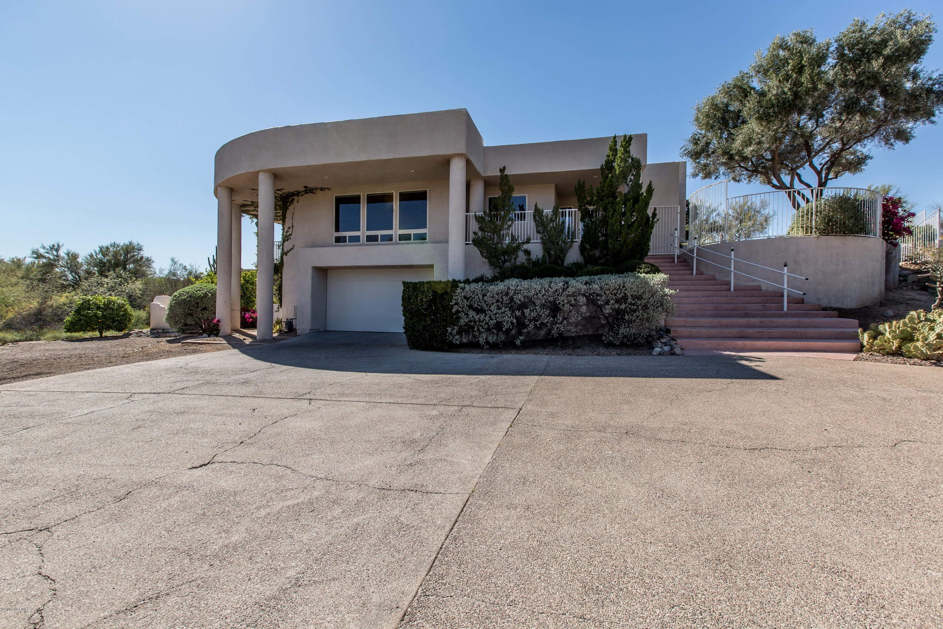 Well-maintained, super-sized custom home on 1+ acre with amazing outdoor/indoor living space in sought after Monte Del Oro estates! The home sits nestled in a private cul de sac location. Outdoor amenities include a stunning negative edge pool with waterfall and solar heating, as well as a spa and built in BBQ area. Large bonus room on the lower level and a HUGE 4+ car tandem garage for all your toys and space for a workshop. Inside are open and bright living spaces including a great room floorplan with views of the Catalinas front and center! Custom wet-bar and unique architectural features throughout. The city AND mountain views abound from both inside and outside this majestic home. Located in the heart of Oro Valley close to shops, restaurants, and award winning schools, this is it!