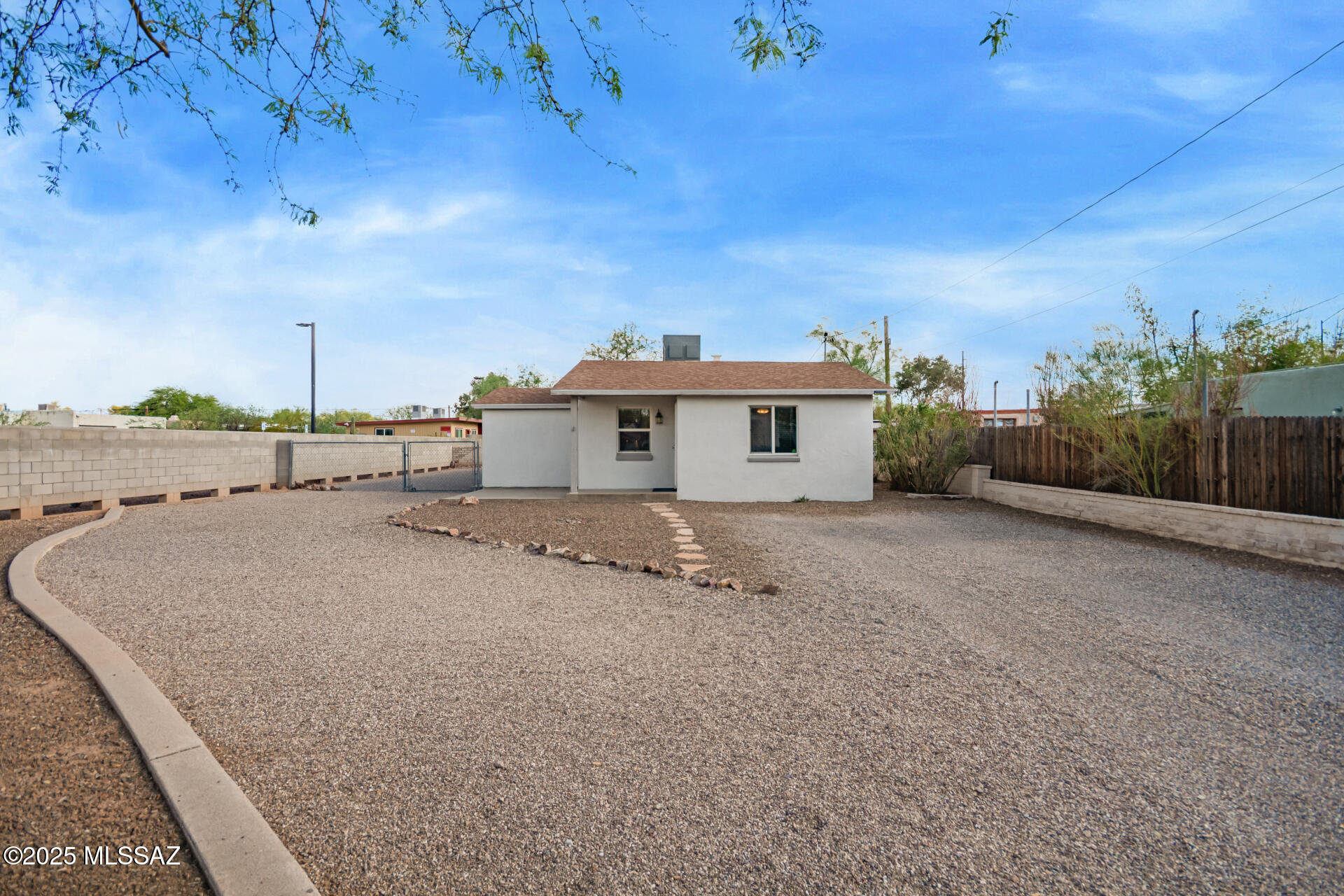 Seller shall accept or counter offers between $299,999 - $314,999. This stunning 2-bedroom, 2-bath home offers the feel of new construction, thanks to a full renovation completed in 2016 and the option of a 3.75% assumable FHA Loan. The open split floor plan is filled with natural light and features beautiful ceramic wood-look tile flooring, fresh neutral paint, and ceiling fans in every room for year-round comfort.

The modern eat-in kitchen is a chef's dream, boasting recessed lighting, sleek white cabinetry, stainless steel appliances, and granite countertops. The primary suite offers cozy carpet underfoot and a private en suite with a stylish tiled step-in shower.

Step outside and enjoy not one—but two spacious yards, offering a blank canvas to create your ideal desert oasis. Whether it's a garden, outdoor kitchen, or tranquil seating area, the possibilities are endless. The backyard already includes a fire pit and mature shade treesperfect for Tucson evenings.

Located in the desirable Hedrick Acres neighborhood, you're just minutes from the University of Arizona, Downtown Tucson, shopping centers, restaurants, and several parks including Mitchell, Navajo, and Conner Park. With a Bike Score of 94, it's truly a cyclist's paradise!