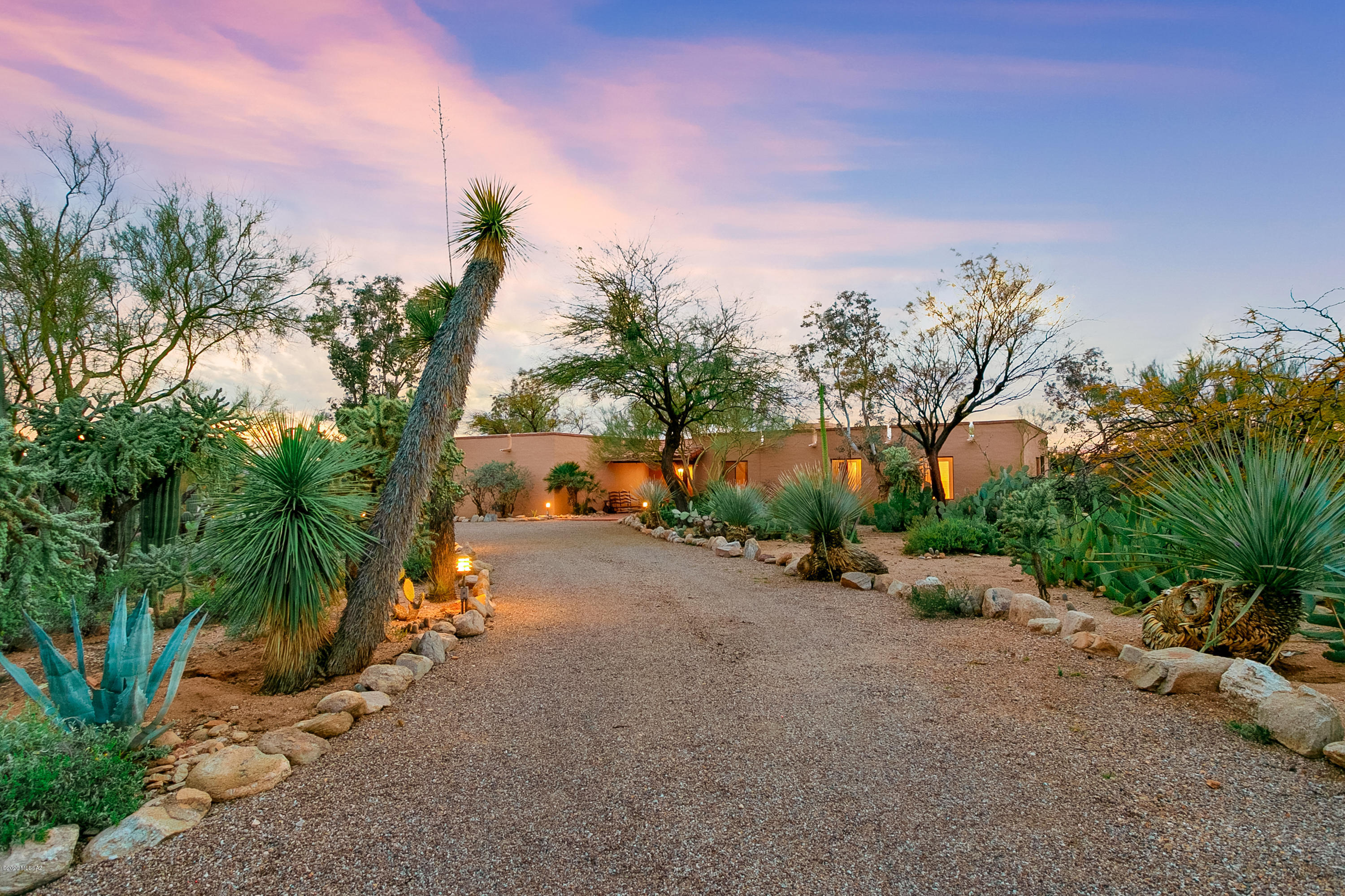 A must see in person! Newly Remodeled Territorial Adobe Home. Private, quiet, close to everything! Stunning sunset & mountain views from inside & out. Circular driveway, beautiful natural desert and exotic plantings. Smooth, lovely undulating topography outback glides into pristine & walkable Arroyo. Walk through front door to open contemporary floor plan w/ 20ft wood beam ceilings, skylights, and tons of natural light. Dream house for displaying works of Art! Gorgeous picture window in living room frames beautiful Santa Catalina Mountains. Wood burning fireplace, 2 large sliding glass doors for back porch access to enjoy sunsets, city lights & Tucson Mountains! New; modern kitchen w/walk in pantry, bathrooms, and laundry room. Lots of storage!