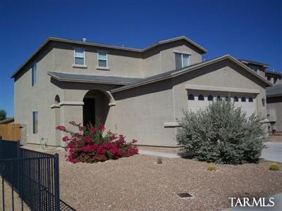 Large 2 story, 2250 sq ft home, 3 bedrooms, 2.5 baths, with living room, family room and upstairs loft, convenient to I-10 access, airport and DM AFB. Kitchen is open to family room and dining area, all appliances included (electric stove) plus m/w. Downstairs half bath. All bedrooms are located upstairs. Large master bedroom with a large walk in closet. Master bathroom and hall bathroom both feature double sinks. Laundry room upstairs off loft with w/d included. 2 A/C units. Two car garage with storage shelves. Nicely landscaped back yard. Alarm system available.