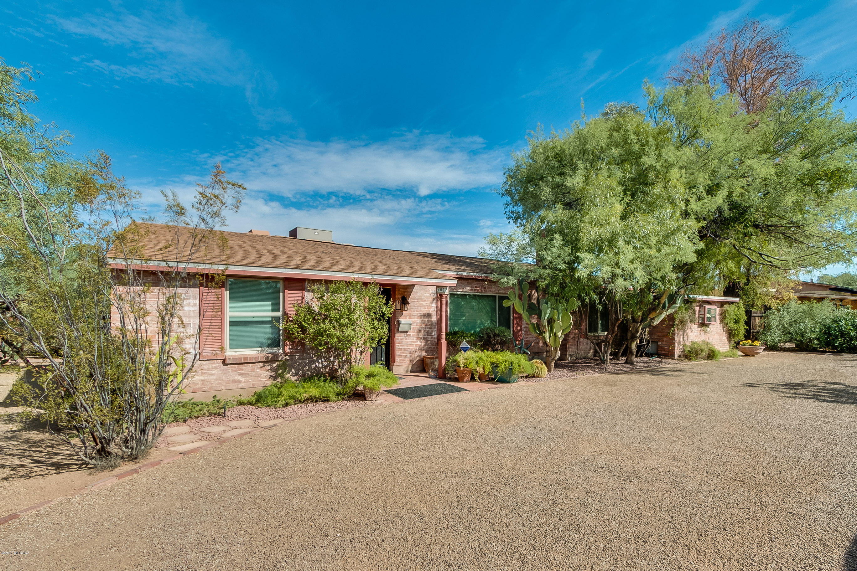 Charming, updated RICHLAND HEIGHTS brick home plus GUEST HOUSE with bedroom, bath, living room & open kitchen. This mid-century 3BR, 2BA home with dual pane windows located on a large .42 acre park-like lot also has another bedroom & studio in a casita within the enclosed guest house patio, & a separate H/C 123 sf office (incl in main house sf). Great outdoor covered sala with natural gas Jennair barbecue, under counter refrigerator, bar sink, wine cooler & slate countertops overlooking the spacious back yard. New roof in 2006; sewer line in 2010; water heater in 2010 with recirculating pump in 2017; auto drip system replaced in 2016. A country feeling while close to the U of A & great dining & shopping. Ideal setup for extended family.