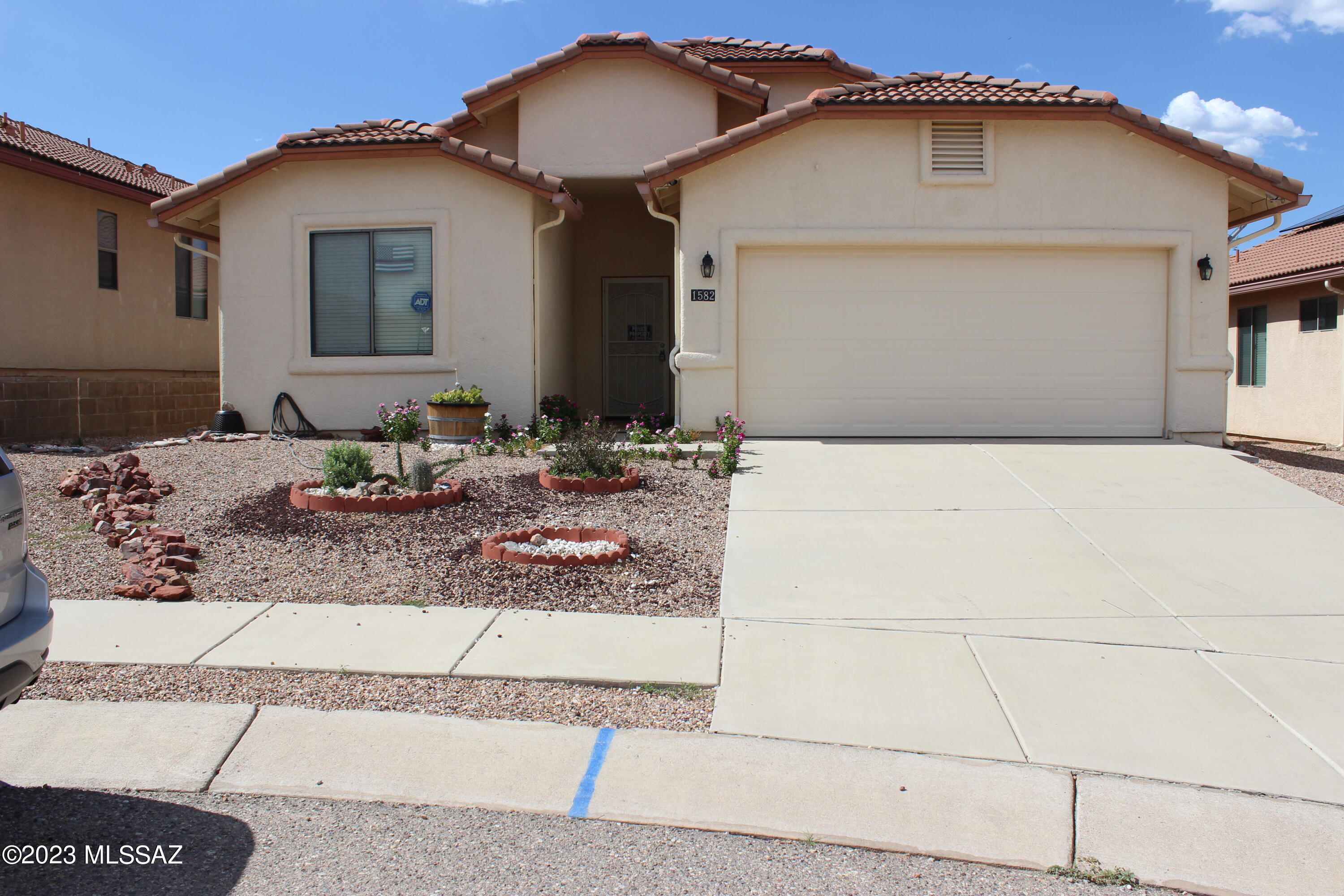 Beautiful, well maintained 3 BR 2 BA home in Cottonwood Bluffs - MOVE IN READY. High ceilings and big windows, allowing natural light, all window coverings will convey.  Great room with gas fireplace in corner.  Kitchen has recessed lighting, island, eat-in area, breakfast bar, pantry, and lazy susan. Appliances include gas stove/oven, refrigerator, dishwasher, and microwave.   Newer washer/dryer included.   Low care landscaping in the back yard with trees, storage shed and grapes! Enjoy the Mountain views from your Screened in Patio, complete with indoor/outdoor carpet, lights and a ceiling fan. Small raised garden bed, long lasting synthetic grass patch and one gate.  ATTACHED 2-CAR GARAGE (extended length). Easy commute to Tucson or Sierra Vista.