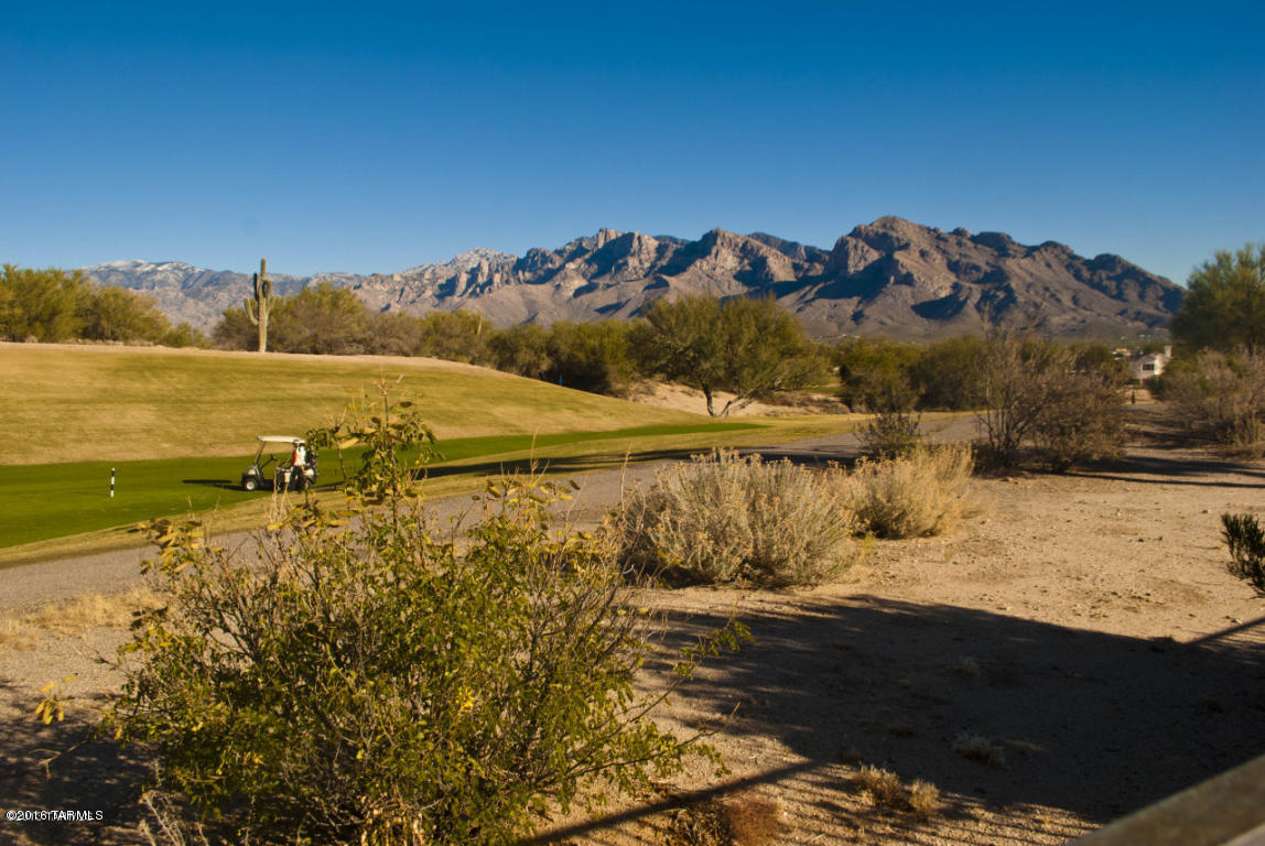 Beautiful Sante Fe Home sits right on the golf course with Unobstructed Mountain and Golf Course Views.  Large open floor plan with large covered patio and rolling shutters