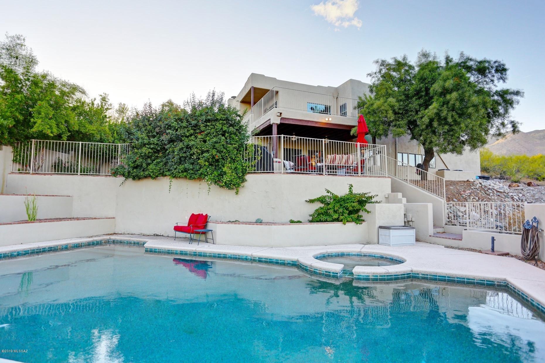 Foothills oasis in the desert! Wait until you see the gorgeous updated Master bedroom and bath, it is serene and spa-like! The hall bath with double sinks and granite countertops isn't far behind. New flooring, new windows, new fixtures, new paint...a whole new vibe. Let's not forget the kitchen and family room- a stunning open space, great for entertaining or a cozy night catching up on your Netflix shows. You easily transition to the amazing outdoor space;  the east-facing patio offers a lovely space for dining or relaxing. There's also a yard big enough for a play structure. Head down a few steps to the large pool and a spa perfect for an evening watching the mountains change colors at sunset while enjoying your favorite beverage!