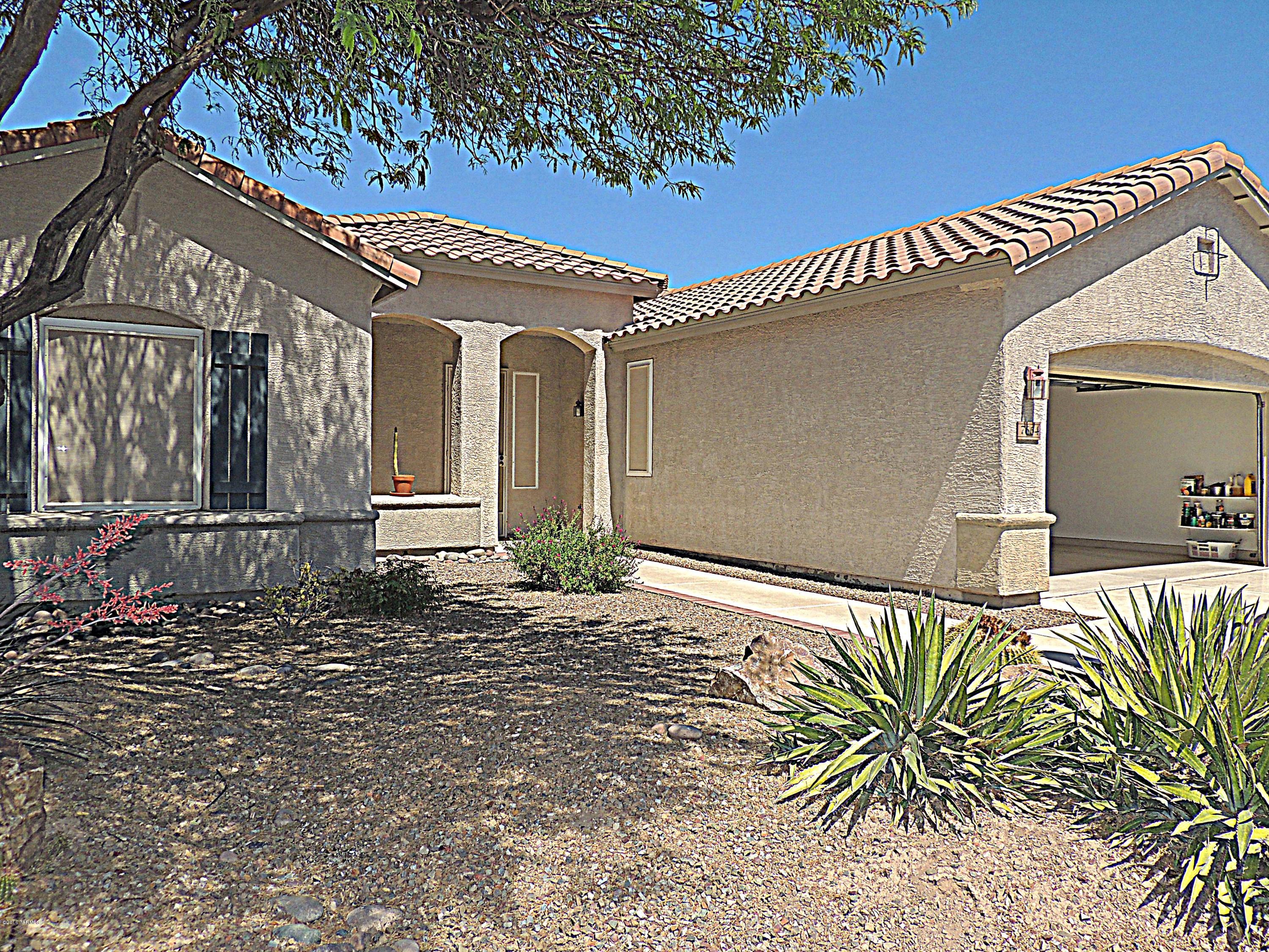 Spacious, light and bright home with soaring ceilings, this home is MOVE-IN READY! The interior is freshly painted (walls, ceilings, closets, pantry and doors) and so is the outside trim, NEW  carpet in bedrooms and Arizona Room and NEW tile in the Master Bath (the rest of the house has floor tile), BONUS room, Guest Bedroom ''Suite'',  custom closet organizer in Master closet. Corian® countertops in kitchen, ALL APPLIANCES INCLUDED. Screened-in patio, privacy screens, NEW HVAC system (2015), newer hot-water heater, EXTENDED GARAGE with storage cabinets. Close to shopping, restaurants, medical and I-10. Many fun activities for body and mind await you at the Village Center!
