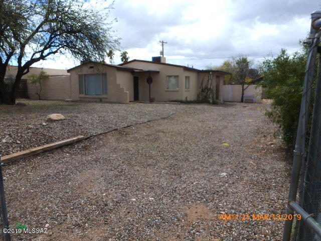 JUST REDUCED! Seller Says BRING ALL OFFERS!  This 3 bed, 2 bath home is centrally located near the University, & close to all amenities, & bus routes. Large lot.  NO HOA. Tons of parking.  Several repairs, including new interior paint. Fans & lights in all rooms.  Big kitchen.  Huge back & side yards. Tons of parking, including room for trailers or RV's. Park 15 - 20 cars! Great for a contractor, or a small business owner, as it is off the frontage road near Grant & Campbell.  University students will love it. Walk to U. of A.