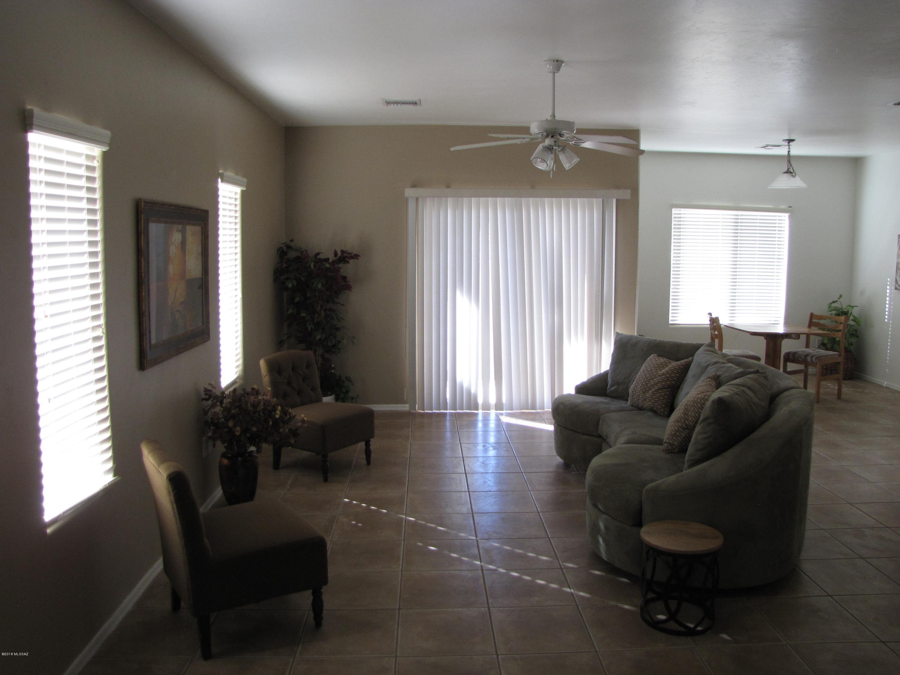 This 2 bedroom, 2 bath home is charming. Tall ceilings give you that open feeling. The kitchen has plenty of cabinets and counter top space. It opens to the living room, great for entertaining. The split floor plan is a plus. Tile flooring in the main areas, carpet in the bedrooms. Vinyl in the bathrooms. The master suite
has the executive height vanity, shower stall and large walk in closet. The hall bath is adjacent to the 2nd bedroom. The laundry room is very functional. The 2 car garage has space for storage and/or work bench. This home is just minutes from DM-Air Force Base, Raytheon, Pima Air Mueseum as well as easy access to I-10. Park/play area is located across the from the home. Pack your bags!
