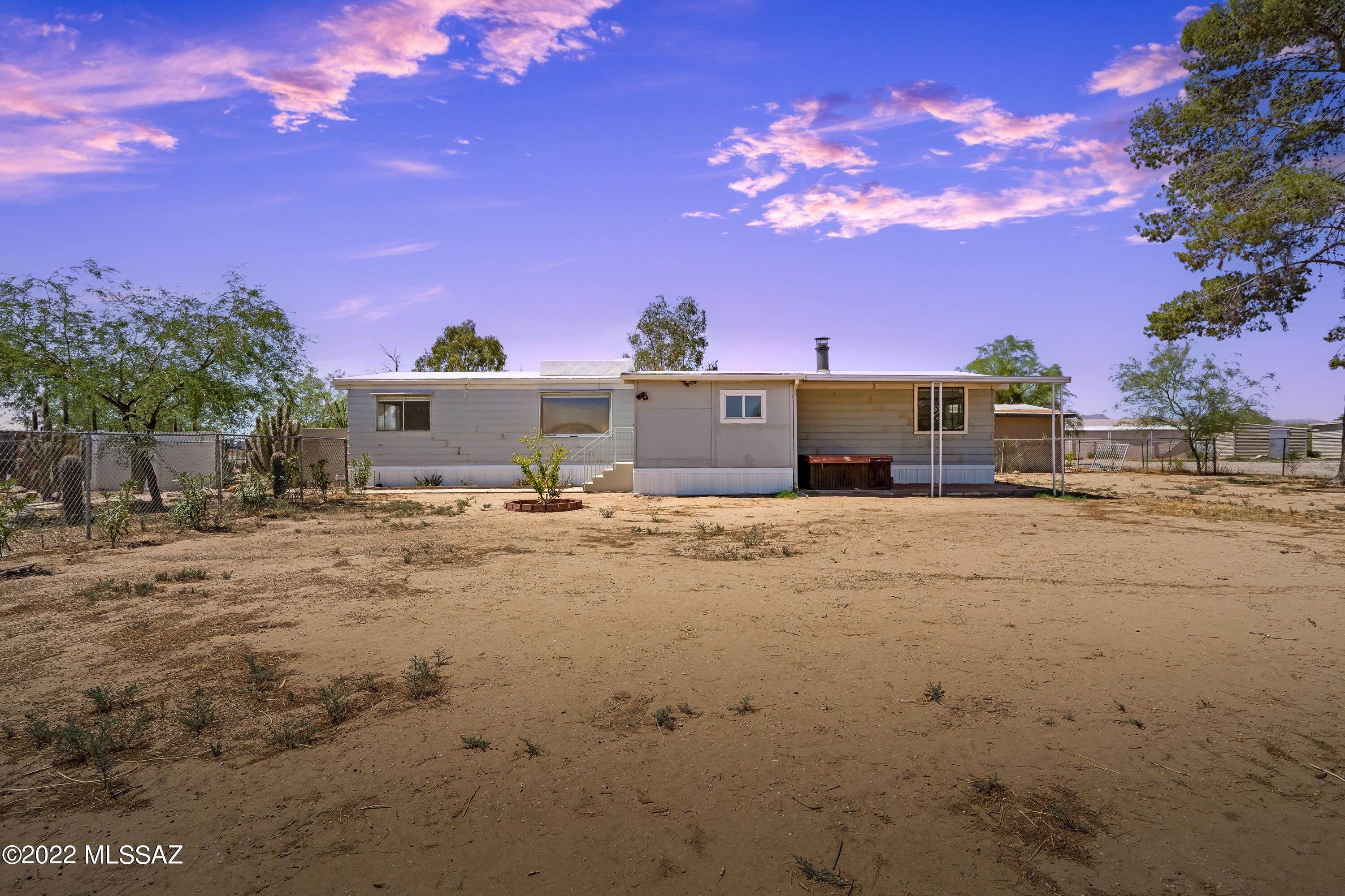 Great opportunity! This property is divided into 2 sections. Both sections have water, electric, and 2 septic tanks allowing for 2 structures to be placed on the property. Great for income options, large families, workshop, and so much more! The home is a large 3 bedroom/2 bathroom with some recent upgrades such as new lighting, new appliances, and more. The main backyard includes a pond, storage sheds, and approx. 1,000 sq ft of storage/shop space. There's a 2 car carport available for parking! Check out this amazing opportunity today!