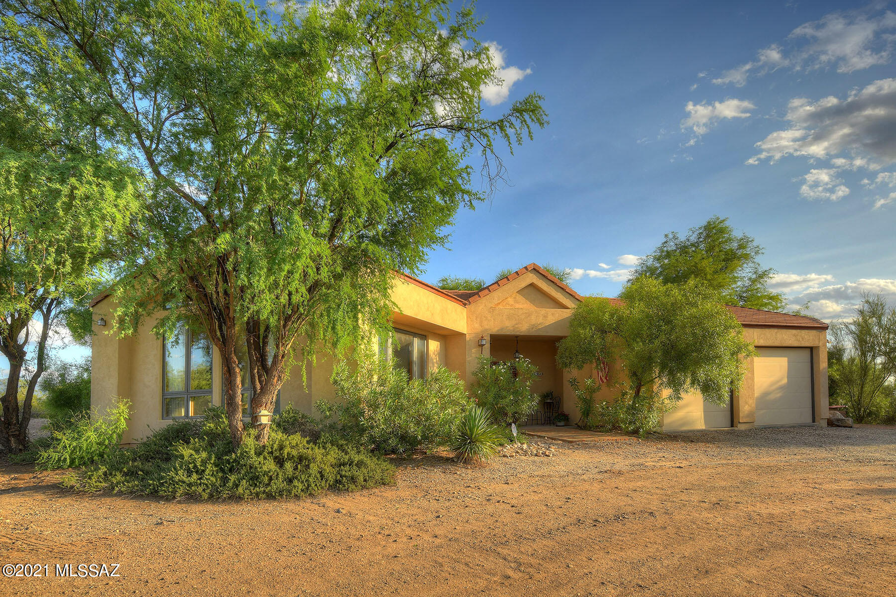 Located in Tanque Verde Valley, this elevated property offers spectacular Mountain Views. The thoughtfully customized designed owner builder home affords many special builder touches.  The open floorplan flows so you have views from most of the rooms. A large Great Room with Soaring Windows captures the Catalina Mountain Views. Dining Area and Kitchen all flow from the Great Room. The backyard features a pool area with a pebble tech pool surrounded by lush foliage.  The area off the back porch has sitting areas, a fountain and additional space beyond the fence for a total of 1.22 acres.  The home was built with a steel frame, Monier Cement tiled roof and Hurd aluminum clad wood windows. Situated on a small road, 1 of 3 homes. Seller to entertain offers b/w $650K to $675,000, range price.