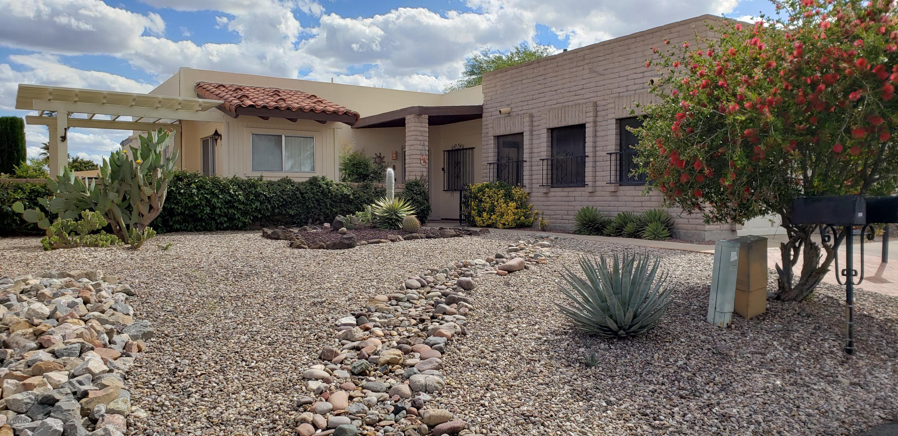 Don't miss this sweet home with a mountain view in Desert Hills II. A nice upgrade is the addition of a light and airy breakfast room featuring a vaulted, beamed ceiling with sliders to the west courtyard and also to the east breakfast patio  There is tile throughout the entire house and a new master bathroom vanity, hardware, lighting & comfort height toilet. Kitchen has custom pull out drawers in all lowers.  The Arizona room is a nice space usable for hobbies, an office or even a third bedroom.  A retractable awning makes the patio a great place to enjoy the full-on view of the Santa Ritas.  Nice walk-in closets in both bedrooms. Roof recently recoated and HVAC new in 2012.  Home is close to golf and the DH GVR Rec Center. It would be a perfect place for next winter's Arizona getaway.