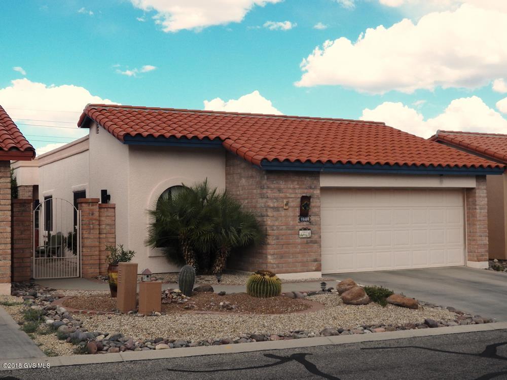 Move-in ready 3BR home with easy care tile floors throughout, as well as ceiling fans and plantation shutters. A large Pella picture window in the dining room provides a panoramic view of three mountain ranges and desert/golf course. The kitchen, with a breakfast bar and nook, has a pass-thru to the dining area. Kitchen and both baths feature tile counters. The screened patio serves as an extension of the living room. A 10x10 workshop/storage area greatly enhances the value of the 2-car garage.