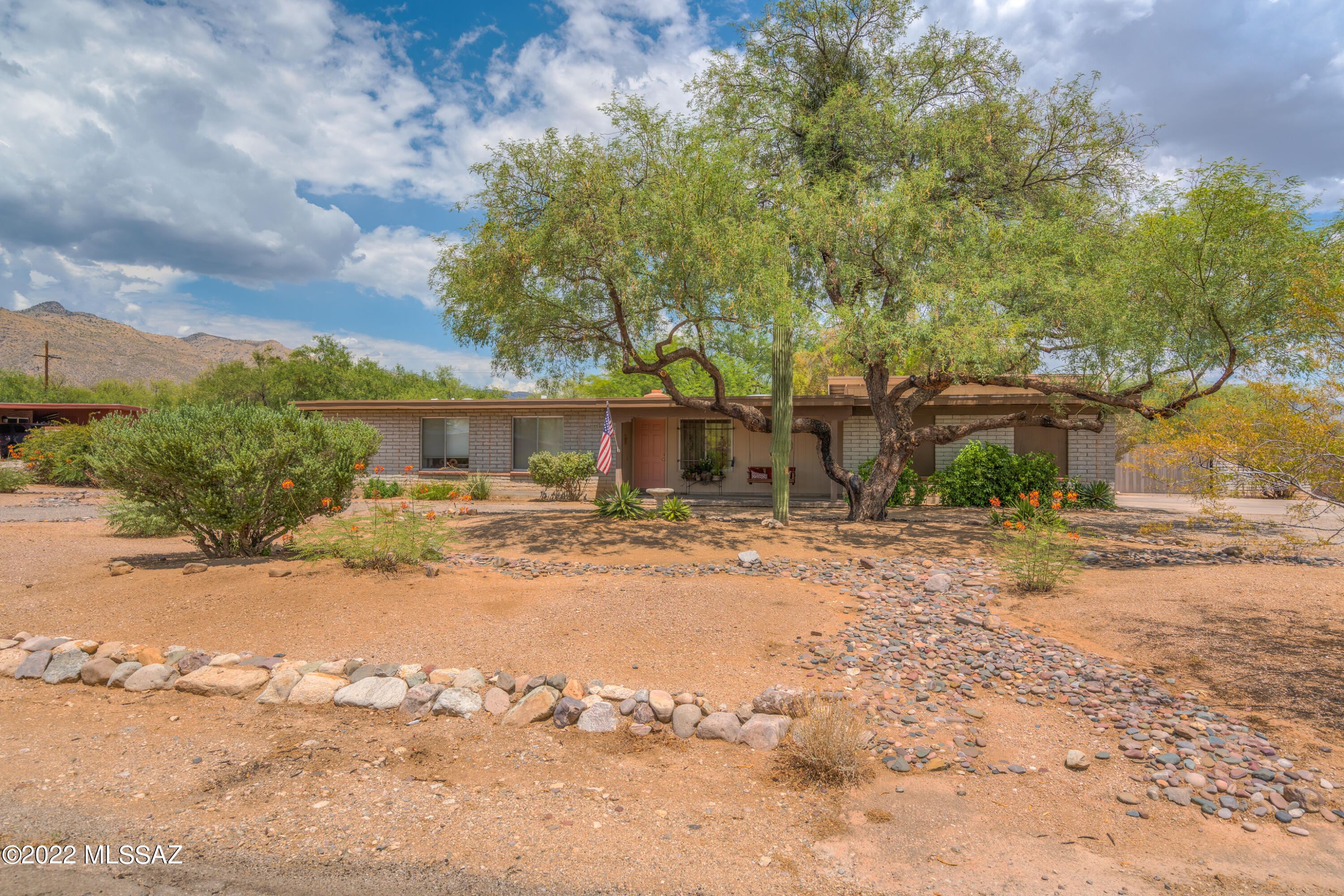 Welcome to this well maintained - Tanque Verde Valley Home located on .59 acres with 2,403 square feet, 4 bedrooms, 2 bathrooms, Living Room, Great Room(Flex Room) &  a extra large laundry room with space for an office, crafts room or ???Currently  being used as a sewing room & office. Zoned heating & cooling. Mature trees & landscaping. Double gate entry to the backyard to house all of your toys, Storage shed conveys. Ceiling fans in all bedrooms. Skylights for natural lighting. Roof recoated last year. Slump block construction, NO HOA. Kitchen has a butcher block island, lots of storage cabinets & a  built in desk unit. Enjoy the cozy beehive fireplace in the kitchen nook area. Covered Patio in the front & back yard. Close to Mt. Lemmon. Circular drive. 2 car carport. Welcome Home!