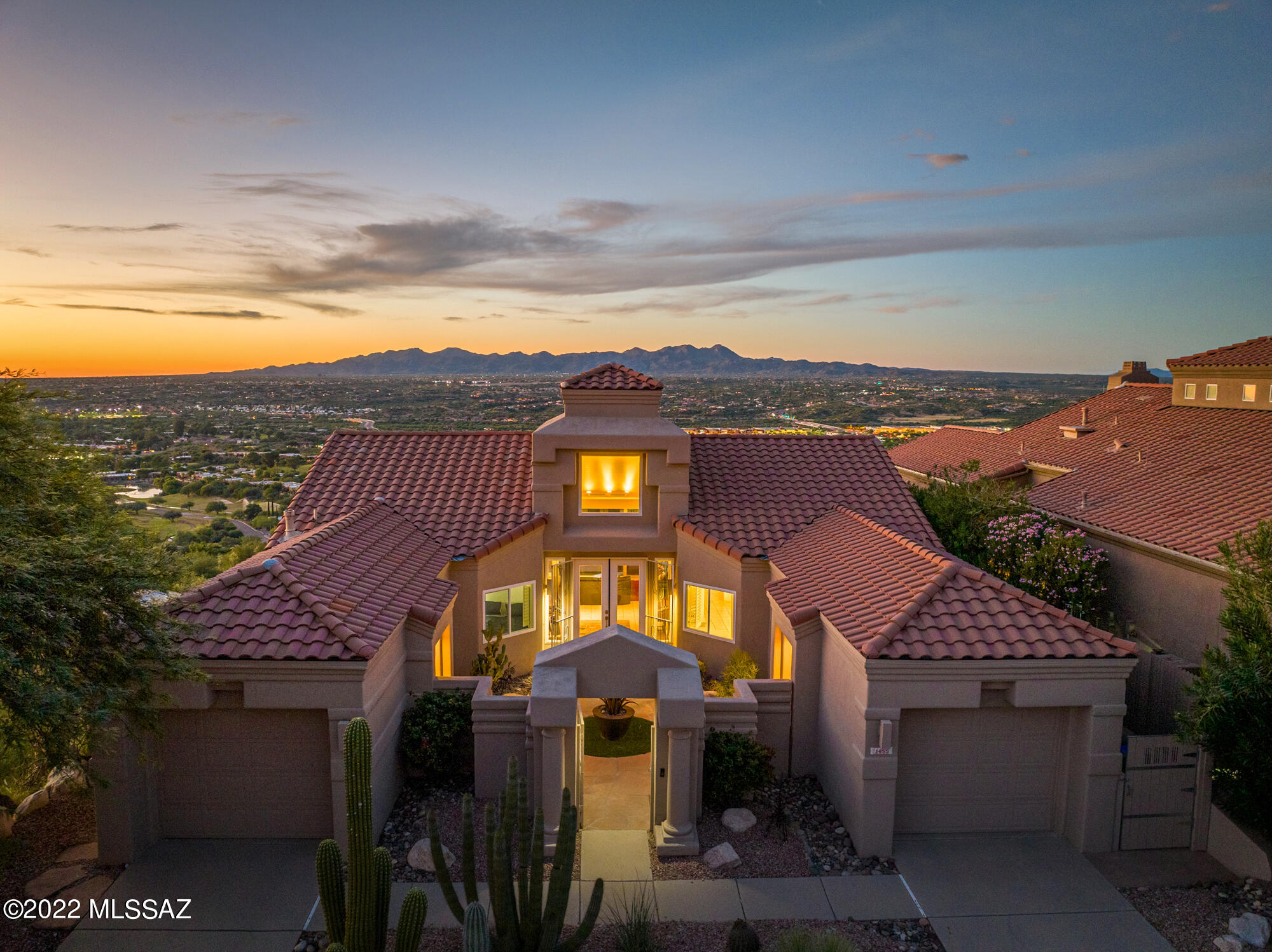 Best views in Oro Valley! Private home, set high on a ridgetop in the prestigious, guard gated community of La Reserve offering unobstructed views of 7 mountain ranges plus sunset & city lights. This striking 3BD/2.5BA (1,984 sq ft) home situated on a private, corner cul-de-sac. Enter to find soaring cathedral ceiling and floor to ceiling windows to capture the spectacular views & city lights. Main living area flows to chef's kitchen hosting granite counters, 5-burner cooktop and double ovens. Retreat to the Owner's suite w/ luxury bath hosting dual vanities/closets & walk-in shower. Second bedroom with views. Private guest quarters has en-suite bath. Additional powder room, plantation shutters, skylights, flagstone patios. This home offers complete privacy & forever unobstructed views.