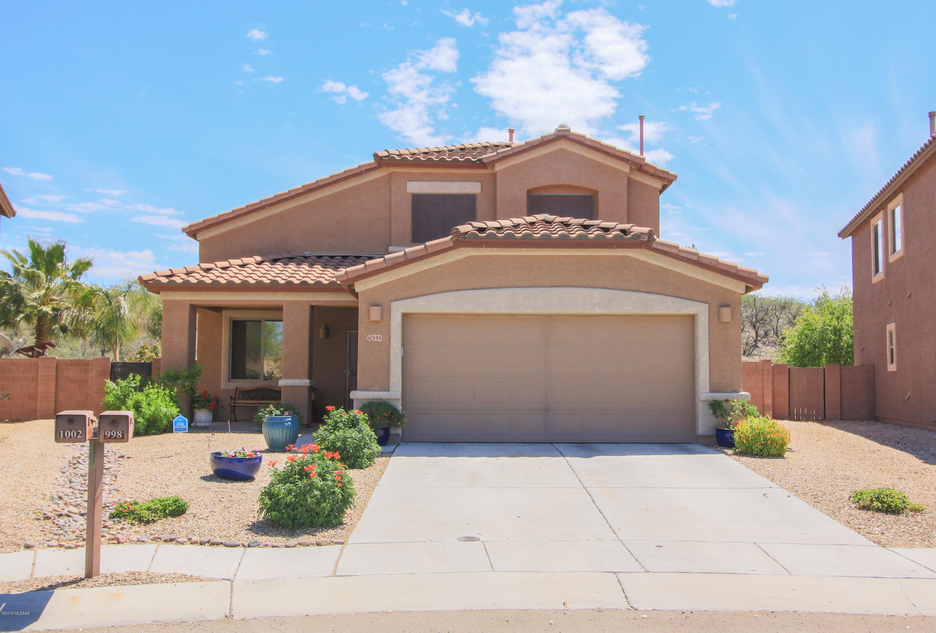 Stunning Sahuarita home! Situated on an acre of one of the nicest lots Madera Highlands has to offer. Immaculate home with over 75k in upgrades! Gorgeous custom kitchen, granite, Travertine flooring, built in entertainment center, oak staircase, and more! Open floor plan ideal for families and entertaining. Sparkling pool outside, yard is very private and peaceful. Close proximity to the near by park and other amenities. This is truly a must see to appreciate!