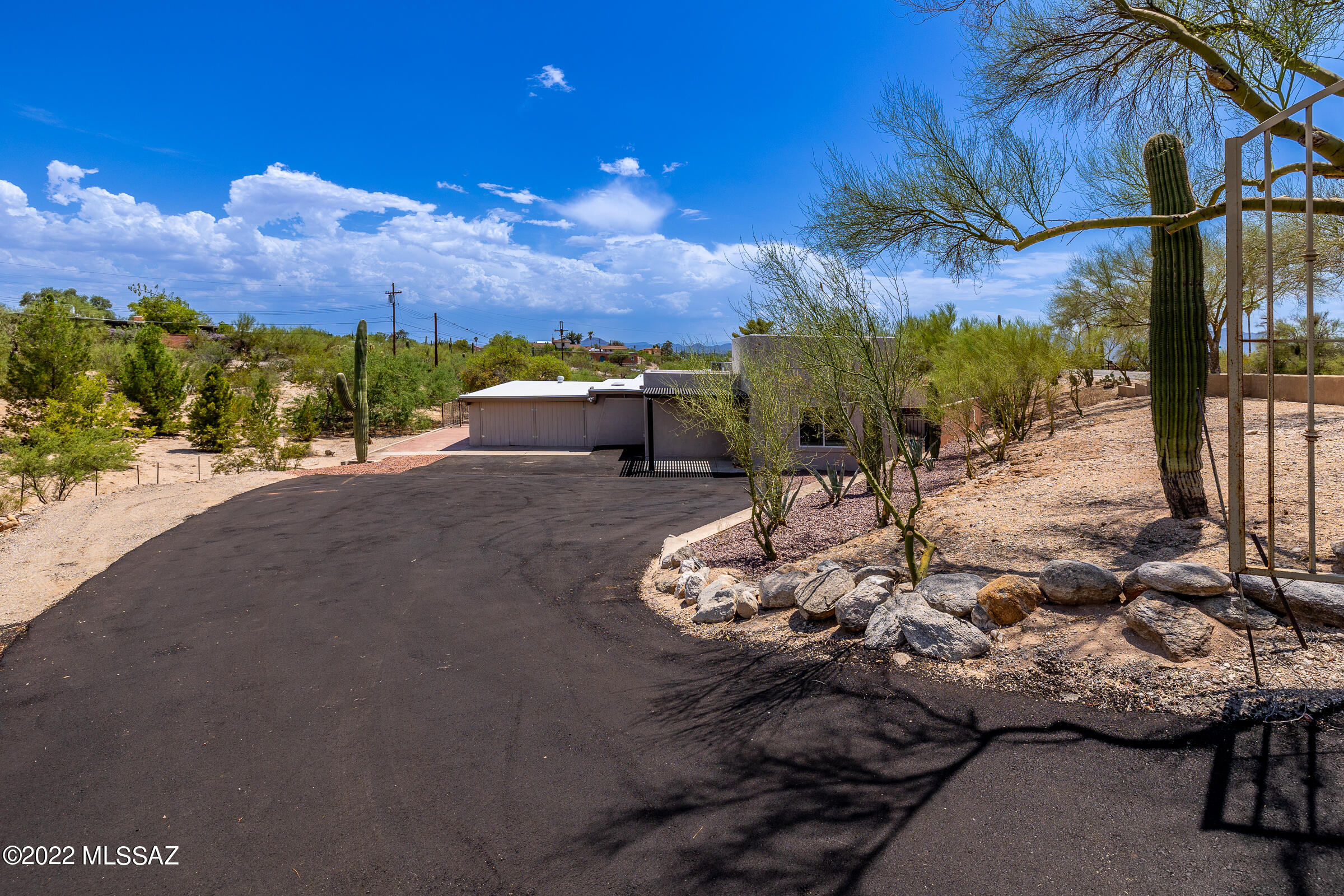 Original Casas Adobe Brick Home that has stucco over the original brick, with a few areas of Brick remaining throughout the home. Charming Backyard with a Pool, Multi-Colored Lighting in the Pool, Beautifully made Custom Iron Work Fence around the Pool, with a lovely sounding Bell, Firepit, Decorative Lighting, Sunset Views Mature Trees. New Exterior and Interior Paint, Large Open Kitchen with granite counter tops and a large island. Shutters in the Living Area. Sellers made the 4th Bedroom off the Master into a Huge Walk-In Closet for you to customize to your liking or expand the Master Bath. Remodeled Jack & Jill Bath with Jetted Tub, dual sinks for the 2 guest rooms. New Flooring in Master and new Carpet in one of Guest Rooms, remainder of home is tile. Ceiling fans throughout. Alro Security System Installed. Roof was recoated 1 year ago. A/C 10 yrs. old but has a warranty for parts from Samon Sons. Large side yard for a garden, an area/room outside off the kitchen is partially finished for storage or a workshop. 2 Car garage has a large storage area off to the side.