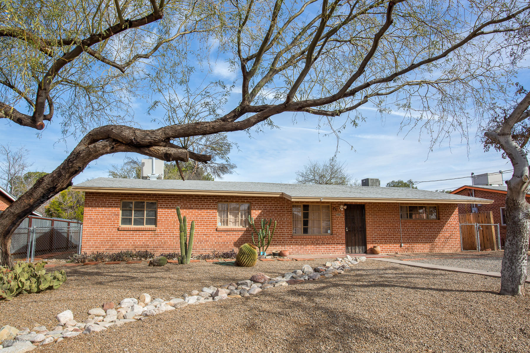 Wonderful combination of updated and charm!  Concrete floors, modern kitchen (with concrete countertops and stainless appliances) and beautifully tiled baths, plus five bedrooms!  Split floorplan too.  Good size living/dining area, plus large bonus area for family room, game room, ??  The yard is fenced for privacy with a storage shed.  This classic brick home is definitely one to put on your list!  Close to U/A too - rental perhaps?  Owner charged $600/room for the past few years.