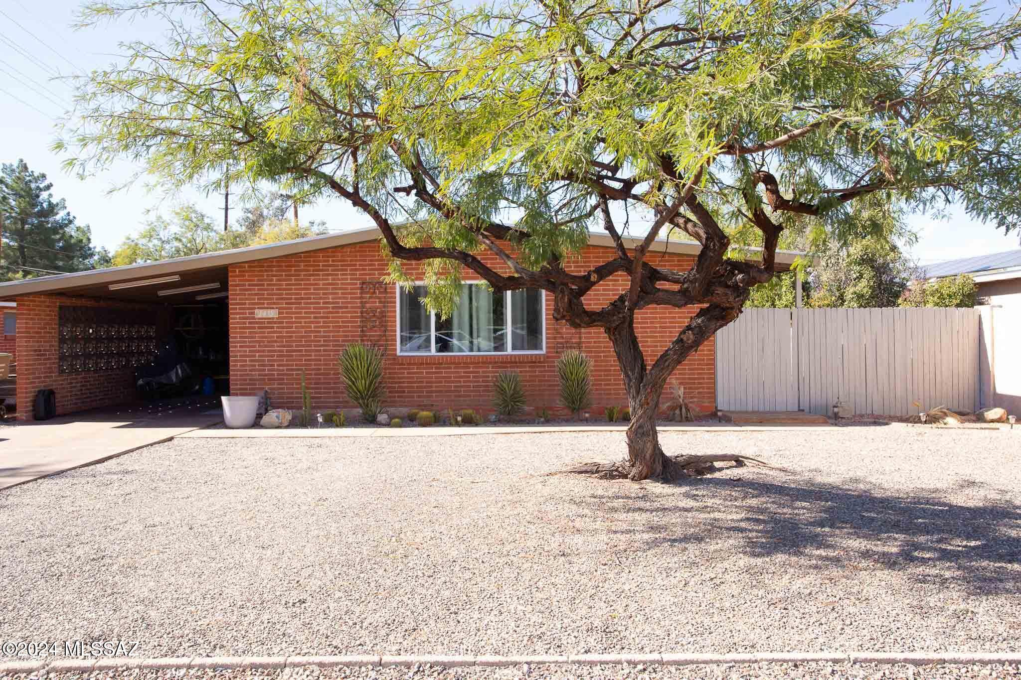 Discover this beautifully updated red brick home located in the highly sought-after Bahia Estates subdivision, offering a prime central location just steps from Pinecrest Park. This 2-bedroom, 1-bathroom gem boasts 1,092 sq. ft. of thoughtfully designed living space, plus a laundry room, carport, and detached garage/storage area. Step inside to find vaulted ceilings and dual-pane windows that fill the home with natural light. The recently updated kitchen features stunning granite countertops with waterfall edge, stainless steel appliances, a stylish backsplash, and ample cabinet space. Bedrooms with walk in closets. The roof has been recently recoated. This move-in-ready home combines style, convenience, and location—don't miss out! Call Agent for more details. French doors lead to the exterior, while modern ceramic tile in the living areas and hard wood floors and carpet in the bedrooms add a touch of elegance. The property also features low-maintenance landscaping, making it perfect for busy homeowners.