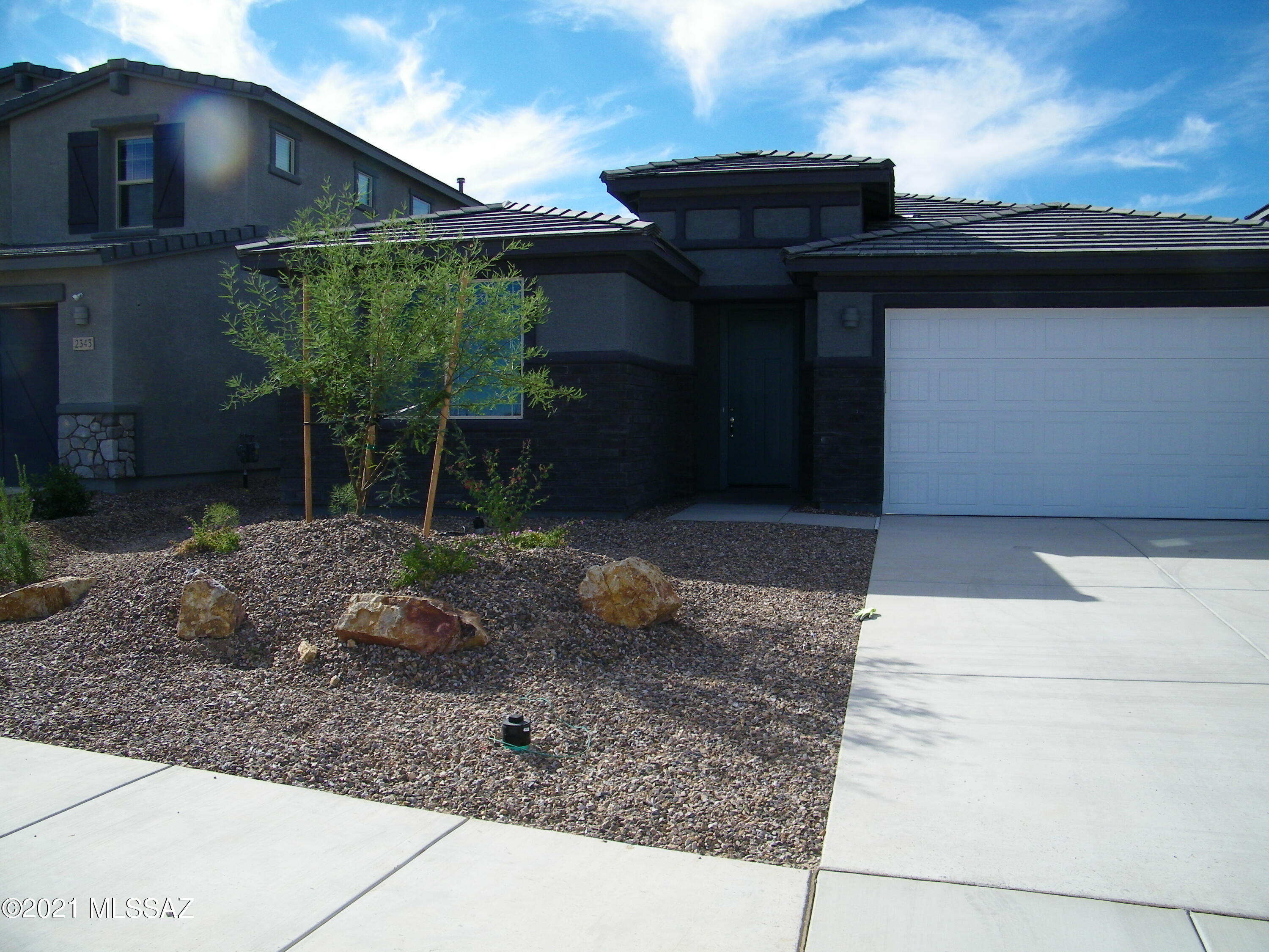 Brely lived in new Meritage home in the fast growing Northwest side. 3BR, 2BA with an office/den that can be a 4th
bedroom. Cook's delight kitchen adjoins the large great room.  1/2 bath in addition to two full baths. Spectacular owner's suite features a large walk-in closet.  Sahuaro Viejos subdivisionl features a one-acre dog park, and an extensive network of trails & parks.
Must see to appreciate.