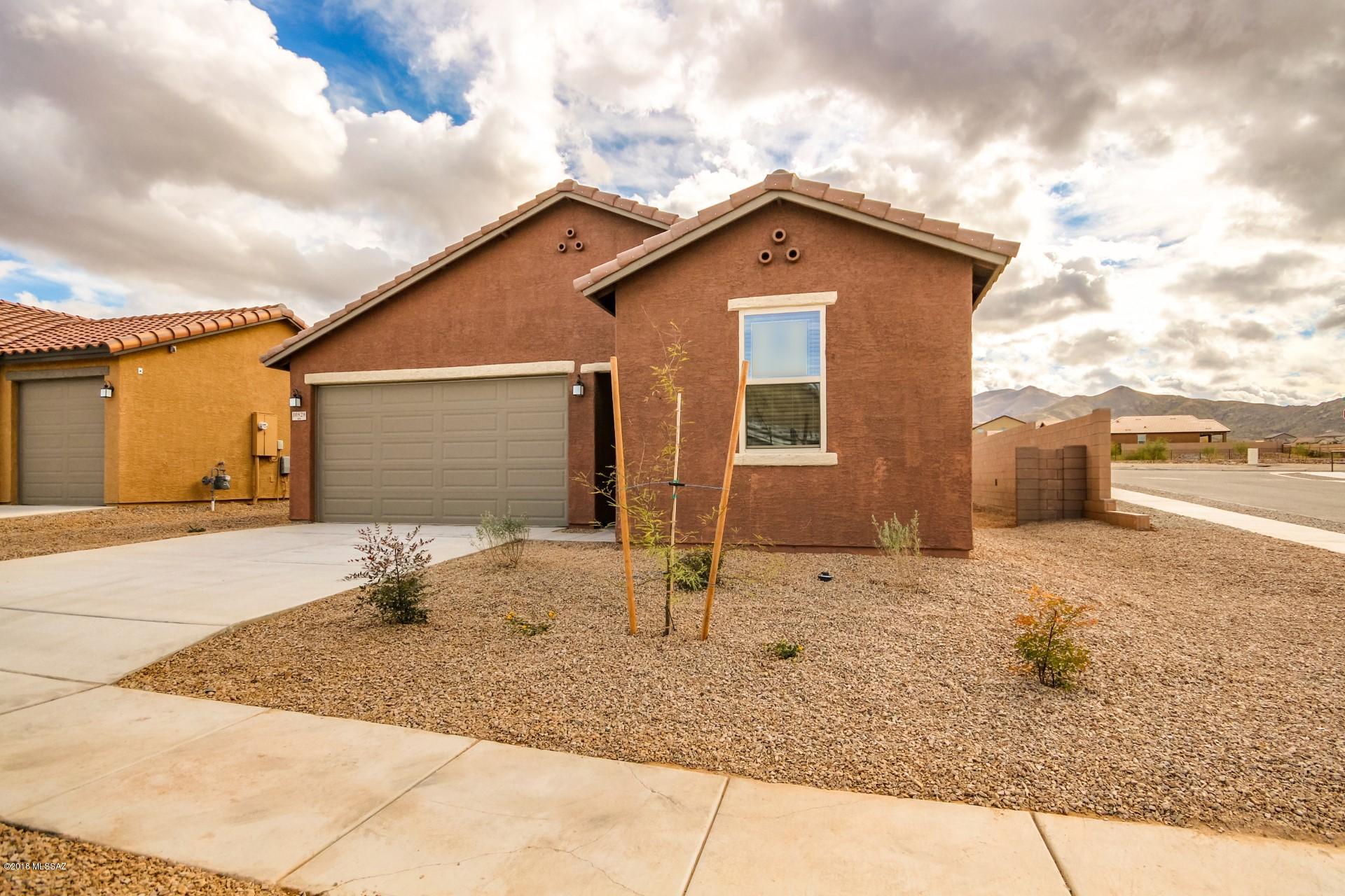 NEW pricing now includes appliances, window coverings & rear yard! W/D, SS Fridge, 2'' faux wood blinds plus backyard landscape rock - Move In Ready! This beautiful home on corner lot with 9-ft. ceilings, a massive great room, classic tile flooring throughout, and lush upgraded carpeting in the bedrooms. The kitchen has 42-in. Timberlake� upper cabinets in Nutmeg, and stainless steel appliances. Cultured marble countertops, a raised vanity, and a spacious shower in lieu of a tub in master bath. Backyard with covered patio has no neighbors directly behind, and a gas stub for a BBQ. Additional features include a soft water loop and warm color tones throughout. Current pricing is contingent on buyer using builder's preferred lender or paying cash and already includes a discount on upgr