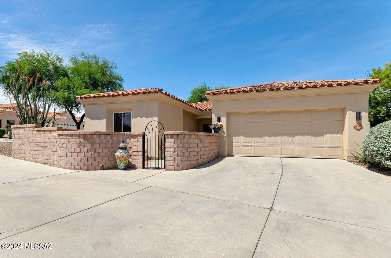 Nestled in the sought-after Vactor Ranch gated community with the landmark 16-foot cowboy boot, this private abode boasts 2 bedrooms, 2 baths, and a separate casita with its own bath. The kitchen shines with remodeling including new cabinets.  New tile flooring flows throughout. Experience luxury in the updated primary bath with its marble vanity and custom-tiled shower. Cozy up by the gas fireplace or unwind in the front private courtyard. Stay cool with a new AC unit and enjoy the convenience of a separate laundry room with storage plus a sink in the garage. Close to shopping, golf, parks, hiking, and more, this home offers both comfort and convenience.