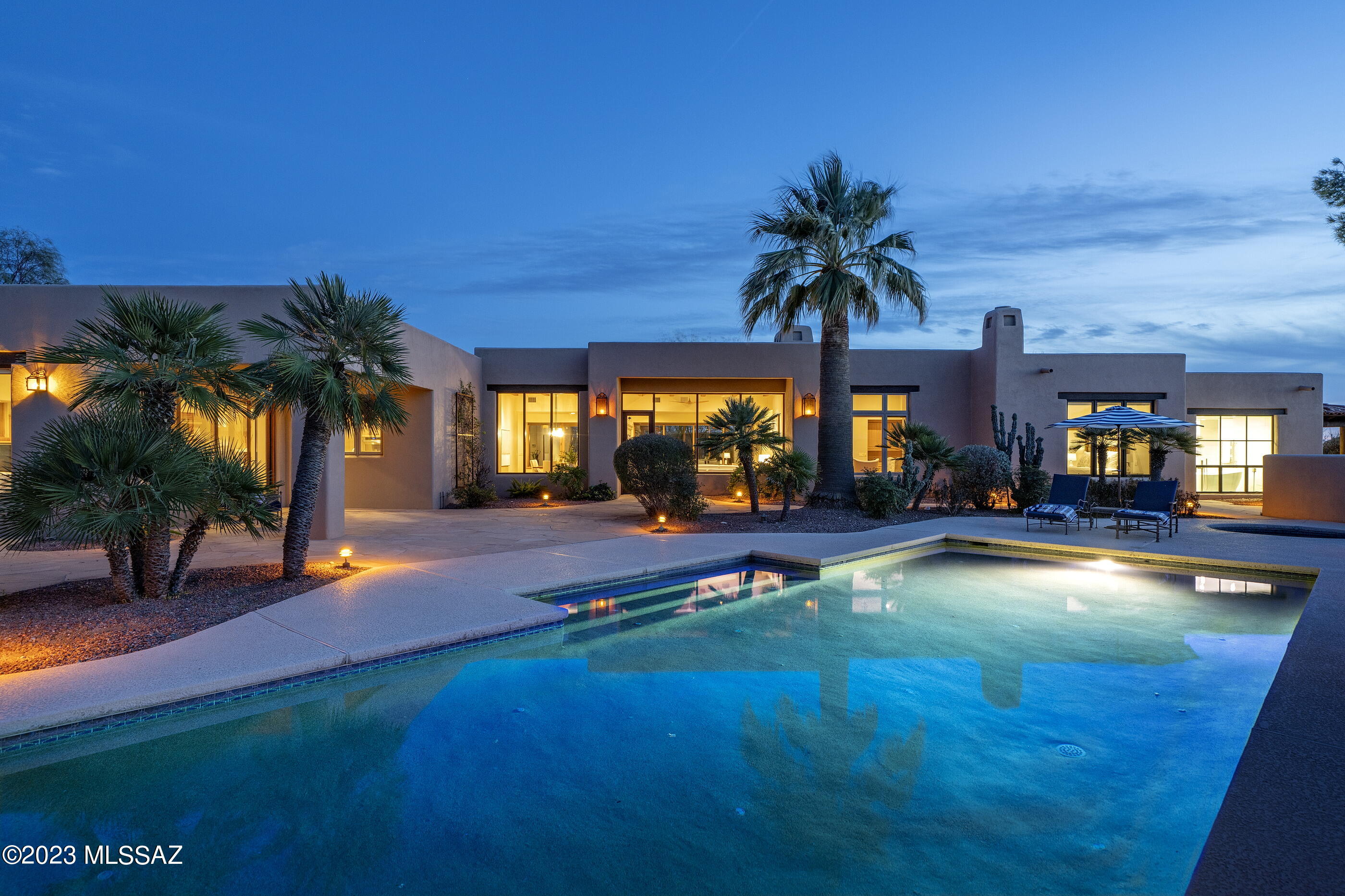 Located in the highly sought after guard gated community of Catalina Foothills 10, set high on a ridge line, with views that stretch out over the Catalina Mountains beyond, while simultaneously nestled within the surrounding natural desert landscape, adding to the feel of this secluded estate. Upon entry, the courtyard features an elongated wraparound veranda that connects the shared living spaces, with a series of glass doors coordinated to tie interior rooms to the spacious outdoor living environments. This exclusive property exemplifies timeless architecture, juxtaposed against modern infused interior updates, with generously proportioned rooms, paired with a thoughtful floor plan that is perfect for both entertaining, as well as casual everyday living. The original design by renowned architect Michael Franks has been reimagined through a series of remodels under the keen eye of Franks and team, retaining the essence of the original architecture, whilst creating a renewed vision of amenities and services an owner would expect from a home of this caliber. Showcasing masterful craftsmanship and exquisite detail, while distributing a delicate balance of intimate and public interior spaces, perfect for winter visitors or families alike.

The updated kitchen features custom millwork, fitting with Wolf and Subzero appliances and cabinetry dressed in satin hardware, surrounding the oversized center island that carefully choreographs the user's movement throughout the space. The owner's suite is sequestered on the West wing of the residence and completely updated in 2021. This award winning design by Debbie Franks features Kursaal white marble tiled walls, with Icon Calacatta marble chevron accents and shimmering pearl glass mosaic ceiling tiles. The centerpiece of the primary bathroom is the Oceano Milano tub that perfectly frames the highly coveted Catalina Mountain view.

As one travels between the individual spaces, dramatic landscapes unfold at every turn, blurring the lines between the indoor and out. Exterior living spaces connect seamlessly, each having been thoughtfully positioned on a North South axis, with views looking out over the resort-like pool and spa, both elegantly and effortlessly situated within the space. Walkways meander through the gardens onto a series of patios, each offering the perfect environment for watching the evening sunsets frame the distant skyline.