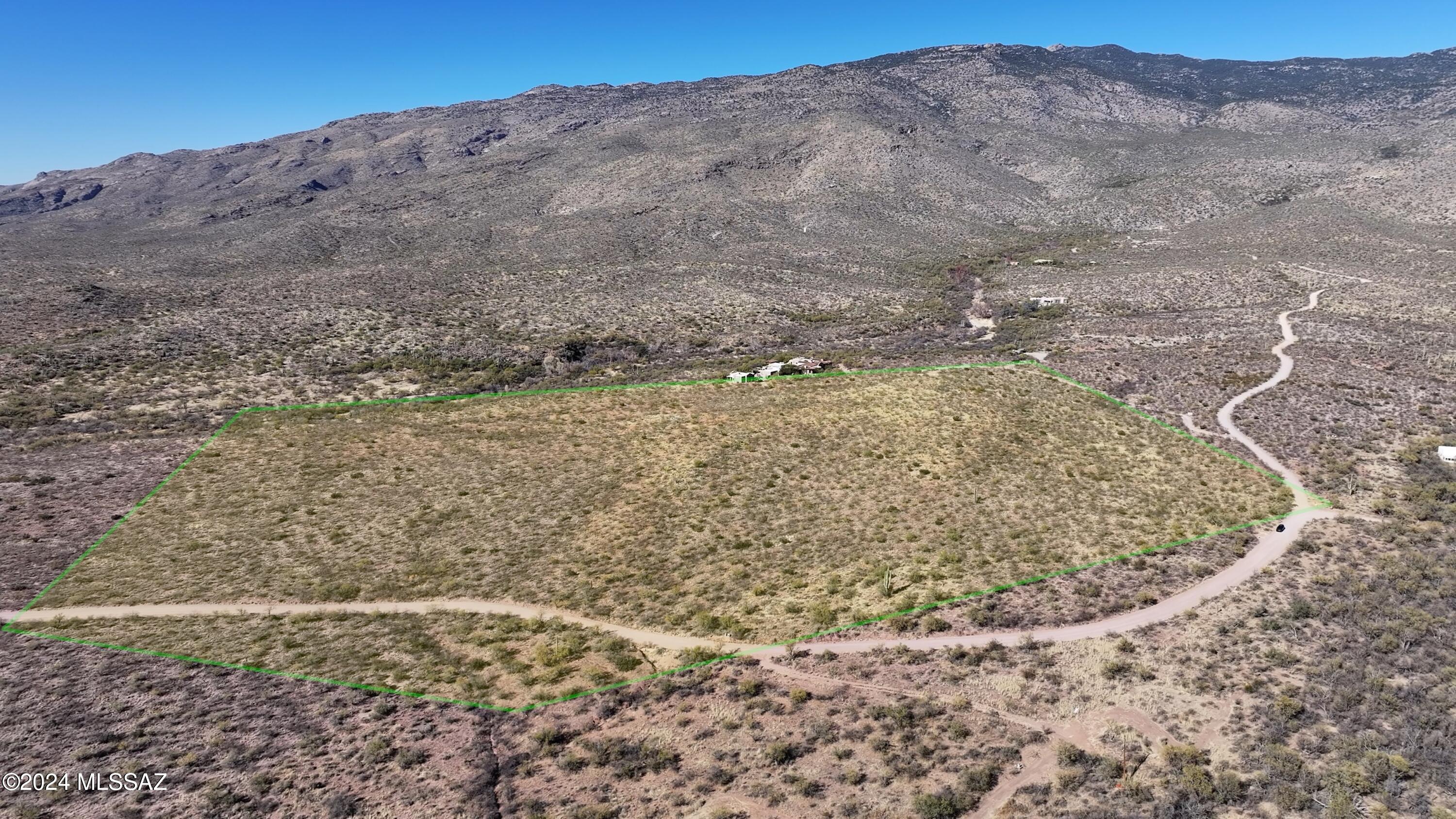 Discover unparalleled serenity on this 45-acre property in X9 Ranch, a gated community of 40+ acre parcels at the base of the Rincon Mountains. Come build you dream home here today.  Bordering Saguaro National Park and the flowing Chimenea Creek, this exclusive area offers breathtaking views of Rincon Peak and 360-degree vistas of the Santa Rita, Tucson, and Sierrita Mountains. With gentle rolling terrain for easy building, X9 Ranch provides a private haven ideal for entrepreneurs, filmmakers, and those seeking peace and tranquility in Tucson's only subdivision restricted to 40-acre minimums. Lot has power and water!