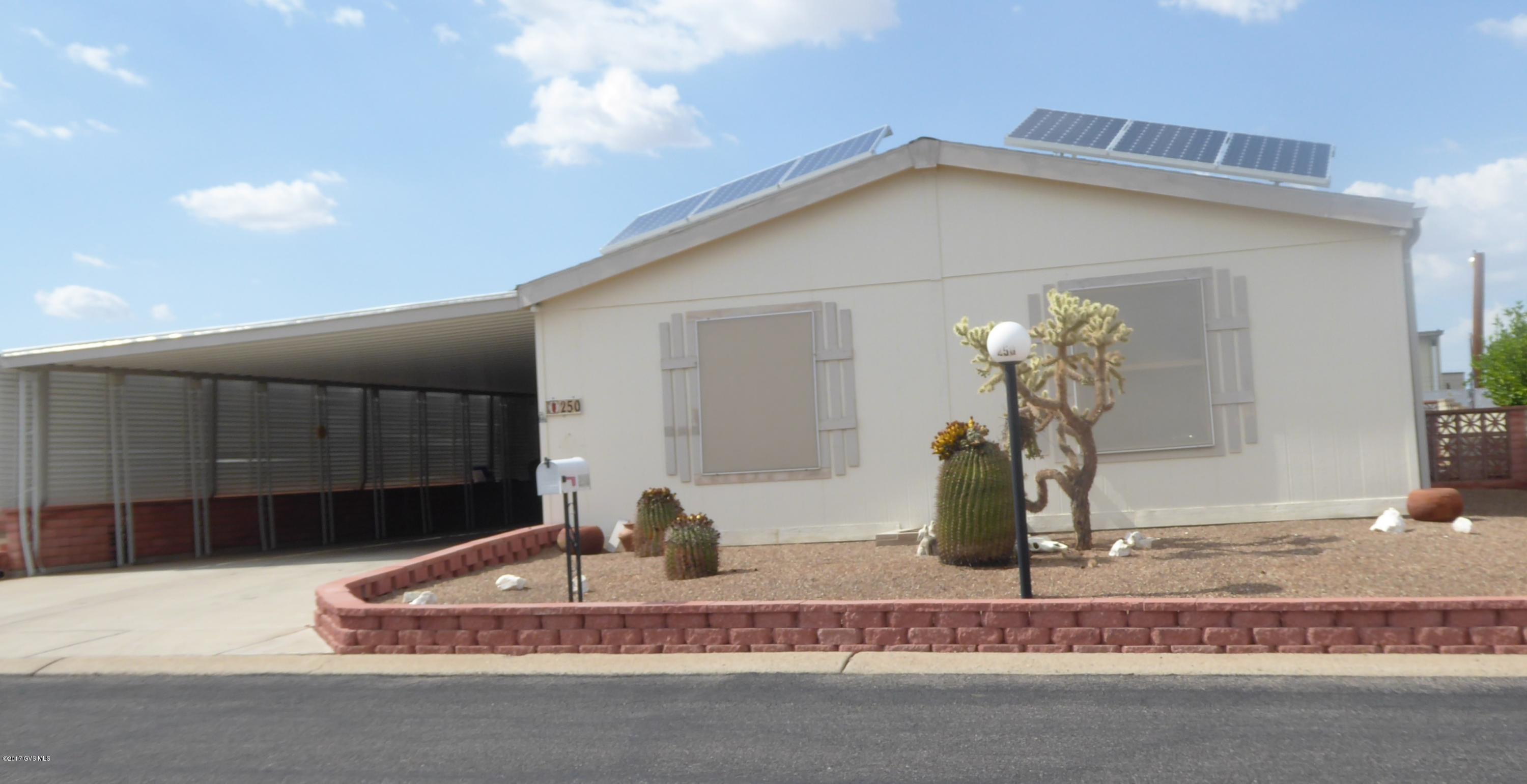 Outstanding wood framed modular house features a double tandem car carport (space for 4 vehicles), large workshop, den, granite counter tops, new carpet, split floor plan, built-in dining room cabinets, easy access shower, and an owned solar system! Enjoy all that Pueblo Estates has to offer - NO GVR fees! No chassis, crawl space has two access points.