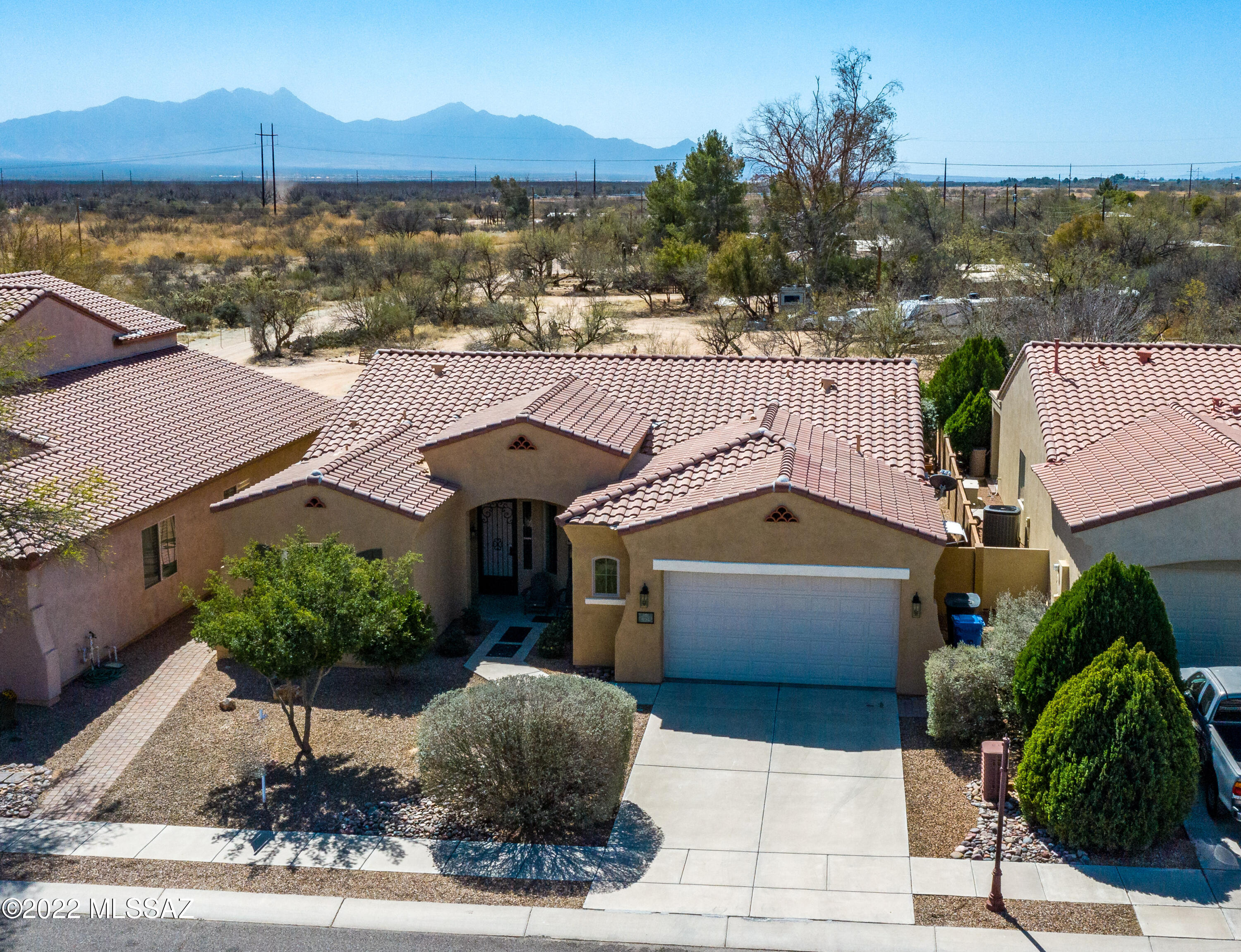 You don't want to miss this wonderful single level home located in Rancho Sahuarita, very close to the Community Clubhouse. 3 bedrooms, 2 baths + a office/den complements this floorplan. The kitchen is open to the dining area as well as the great room making it perfect to entertain family and friends. The oversized primary bedroom is located at the back of the house and offers lots of privacy. The primary bathroom has a walk-in shower, jetted soaker tub and a walk-in closet the size of a small bedroom. If outdoor living is high on your list, this home is perfect for you. With no homes located behind you, enjoy  the breathtaking mountain views. Extra storage in the large laundry room, and spacious garage are an extra bonus as is the OWNED solar. Don't let this one slip away. Welcome Home!