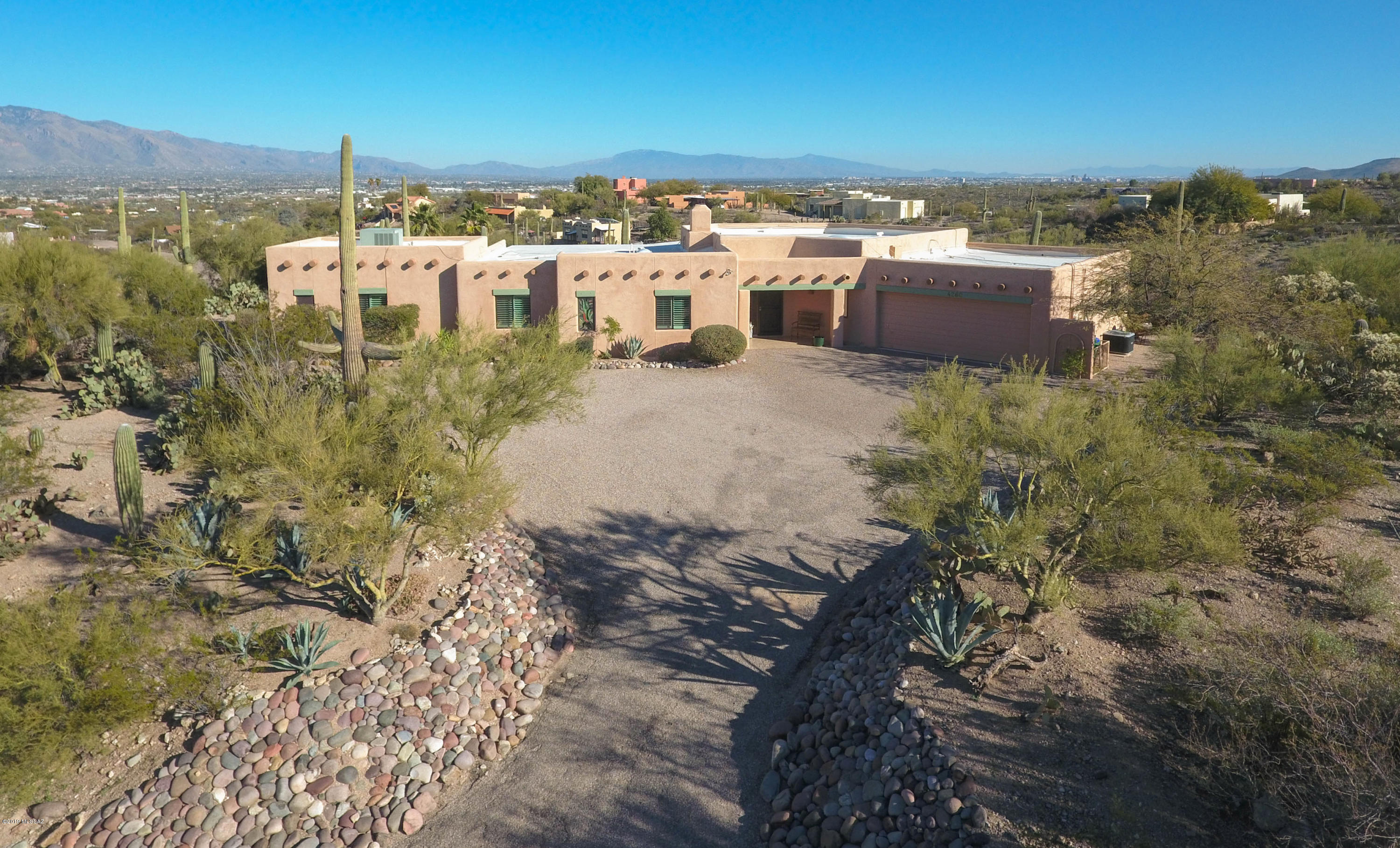 Lovingly cared for home by the original owner.  This is the first time the home has ever been on the market!  Very well situated on a high ridge top with an east facing back yard.  The home has panoramic views of the Catalina Mountains, the Rincon Mountains, the Santa Rita Mountains, and the Tucson city lights at night.  A great room design with an open floor plan and lots of windows create an warm and comfortable lifestyle.  The home is surrounded by natural desert with a minimum required of maintenance.  The 3rd bedroom and adjacent den could be a very nice in-law suite.  Extra large garage and storage room provide plenty of room for your workshop or stuff.  Please take a careful look at the photos for those views!