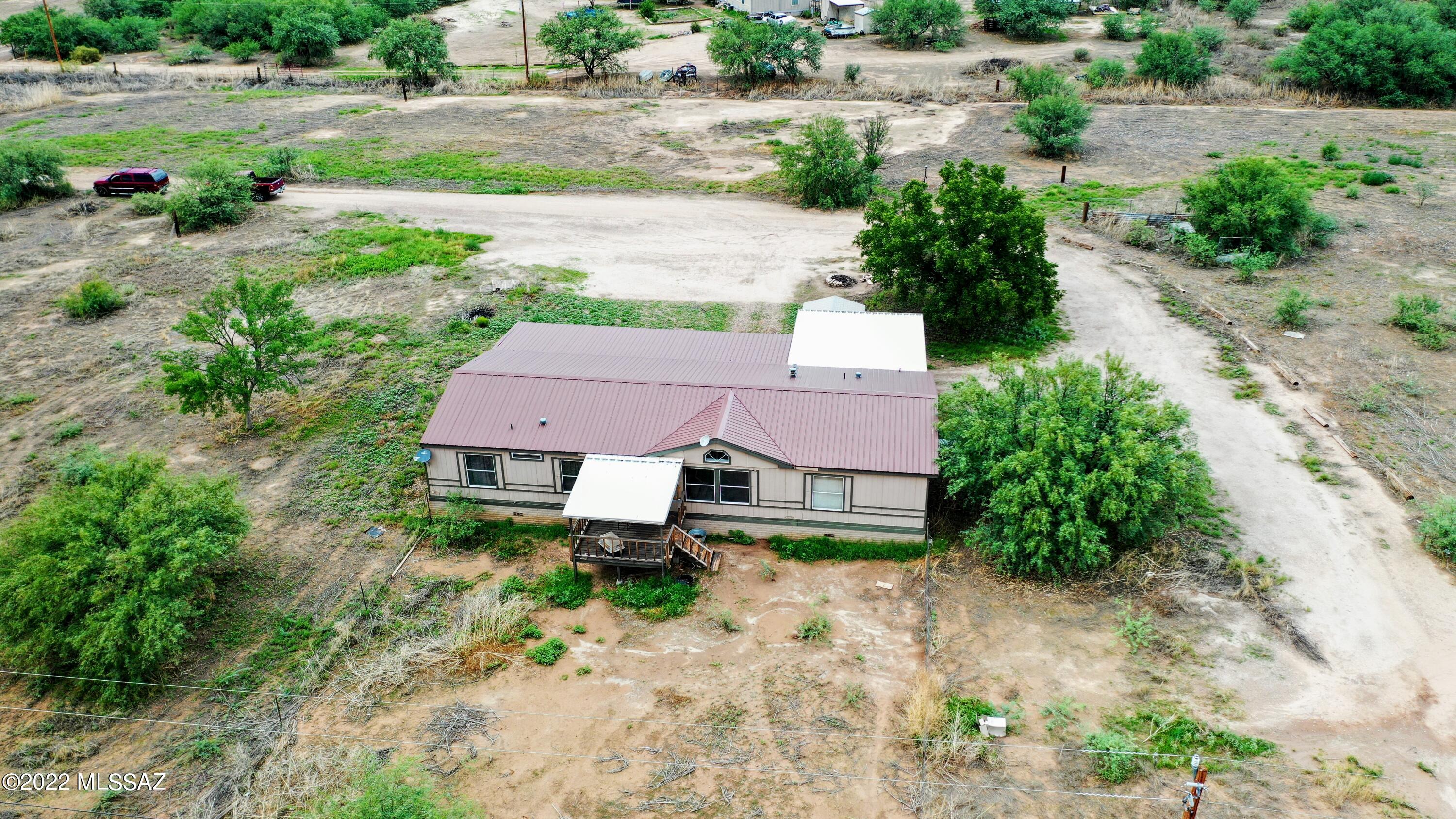 Looking for space with peace and quiet. Check out this 3-bedroom 2 bathroom manufactured home on nearly 5 acres! Plenty of room for horses! Enjoy the views from your front and back covered porches. This home is perfect for outdoor entertaining. The interior is gorgeous as well! This home has a split floor plan with large master bedroom and en suite master bath. There is plenty of room to relax in the living room or in the family room/game room.  Cozy country living can be yours!
