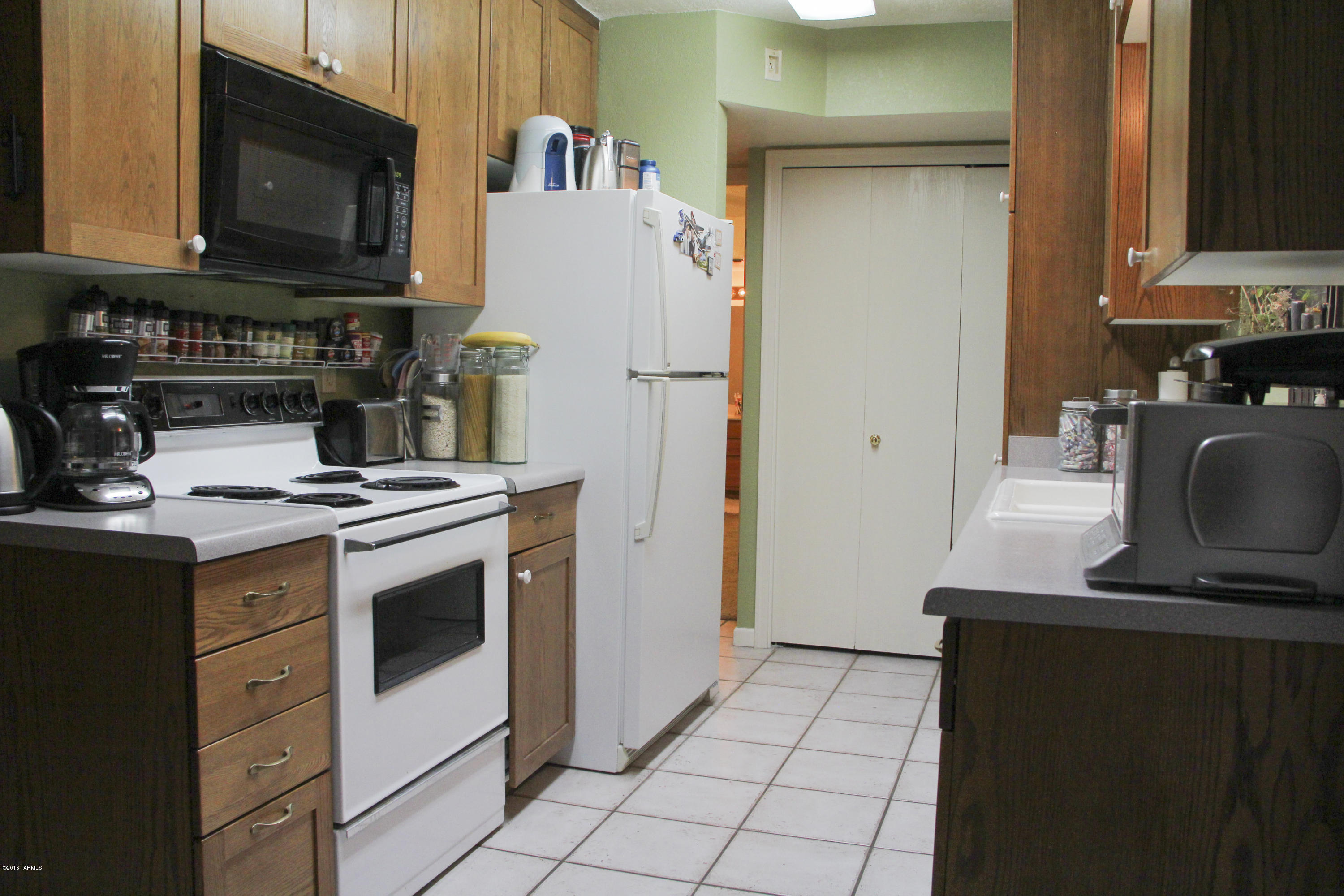 Updated condo in gated community with a completely enclosed 2 car garage, community pool, and on quiet street with N/S orientation; what more do you want? Home features master on the main floor with updated kitchen and kitchen cabinets. Main living space is tiled with newer carpet in master and great room. NO polybutylene pipes! Roof, A/C, and garage door opener were replaced. All appliances stay! HOA includes Water/Sewer plus Personal Area and Common Area Structural Hazard Insurance. Close to U of A and downtown.