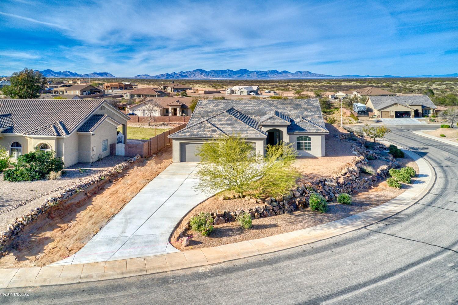 Custom new build construction located in Las Haciendas II, minutes from all amenities. Perched high on a private, corner lot with panoramic
mountain views, this home has it all! TWO MASTER SUITES AND HANDICAP ACCESSIBLE with 3' x 8' doors throughout. Four bedrooms, three full bathrooms. Master
bedroom one has an elegant, jetted whirlpool tub and separate walk-in shower. Plenty of storage in pantries and walk-in closets. Oversized laundry room offers space for
a second fridge or deep freezer. Split floor plan, 10' ceilings with volume ceiling in great room, open to kitchen with maple cabinetry and large island. Custom granite and
tile throughout with upgraded carpet in bedrooms. Three large covered porches - front entry, master bedroom and dining room for entertaining. Gas stub for BBBQ