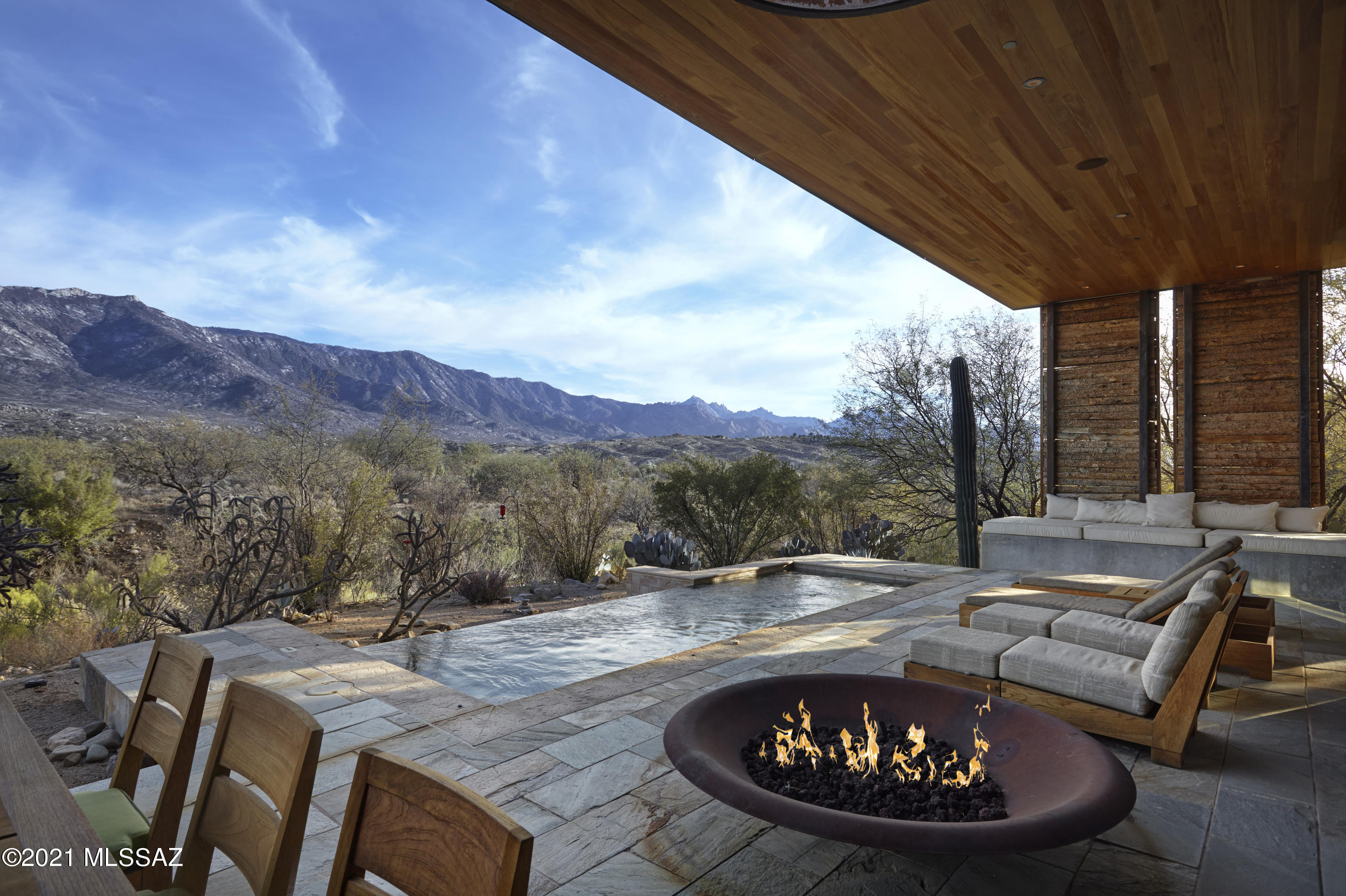 This inspired residence is true retreat. The seamless blend between indoors and outdoors, complemented by unobstructed views of the Santa Catalina Mountains invite you to relax, breathe and connect with nature. Facing east, morning sun illuminates the patio. As light moves throughout the day, the desert unveils different layers of beauty. Colors and materials mimicking those found in the Sonoran Desert have been integrated into the design of this exquisite property. Rammed earth, reclaimed wood, stacked stone, concrete, and quartzite layer texture throughout the space. Each choice made by the architectural team at MITHUN and the award winning design group CLODAGH was done to create both a beautiful and sustainable home.  Awarded the Silver LEED certification by the Green Building Council. This lifestyle, and this home are vastly different. At MIRAVAL, the path is inspired. If living a balanced life is the ultimate destination, then learning to live in the moment is a key means to getting there. MIRAVAL is dedicated to providing unique experiences in engaging environments for those who wish to live life to its fullest potential. There's life, and then there's living. This is living.