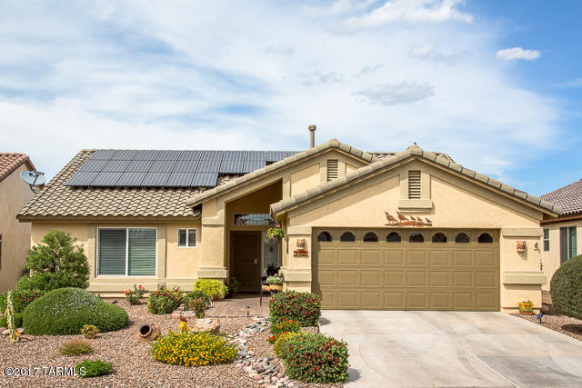 Augusta model with prepaid solar!  Expanded paver patio with a lovely fountain and blooming shrubs and flowers create a backyard oasis.  Meticulously maintained with newer dishwasher, washer and dryer, refrigerator, water heater, kitchen sink, garbage disposal and faucet.  Tile except living room area and master bedroom.  Guest bedroom has wood look tile.  Whole house water treatment system.  Built in desk and cabinets in den/office.  Garage is extended 4 ft.  This just feels like home!