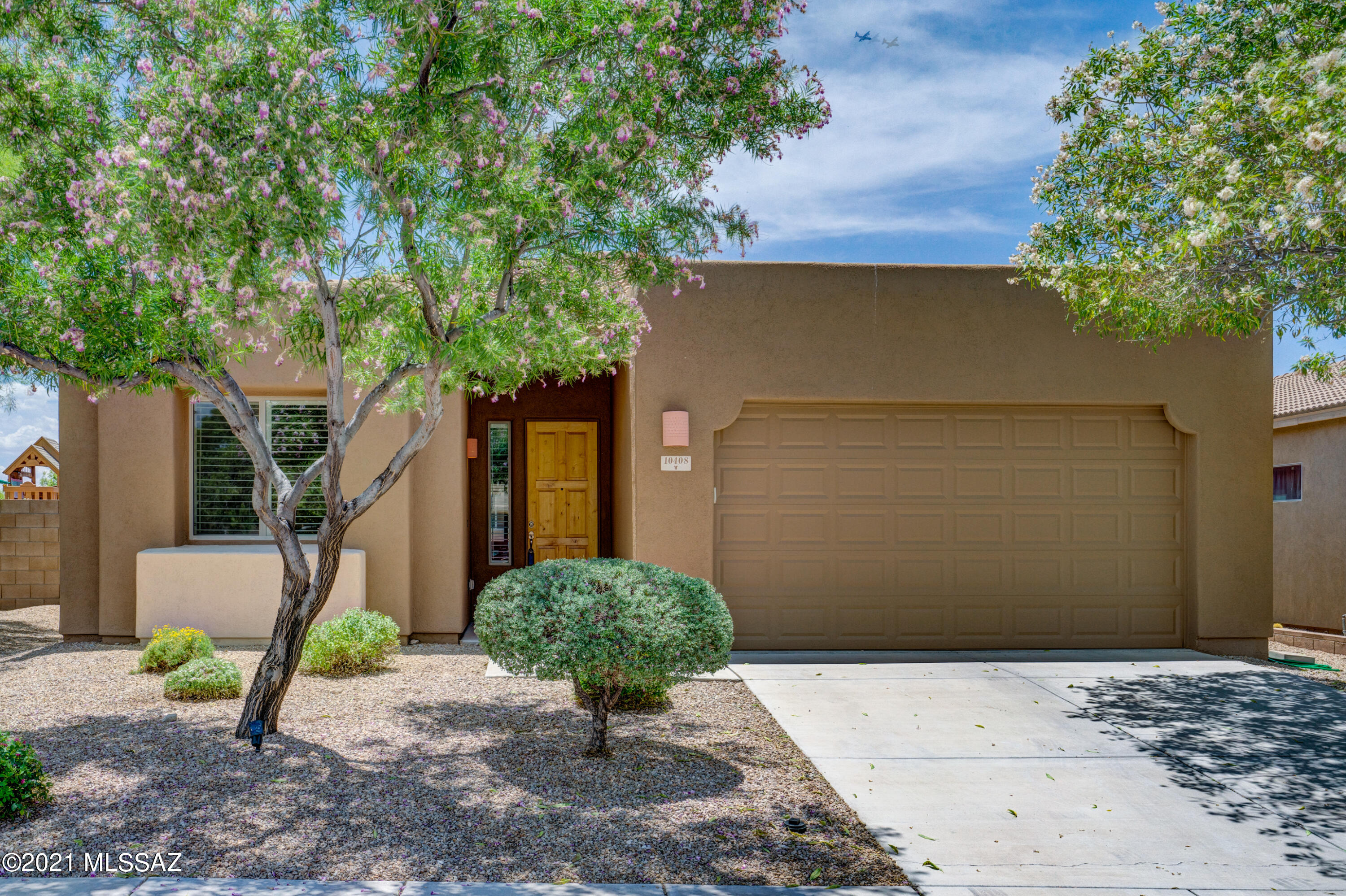 Move right in to this beautifully maintained 4 bedroom, 2 bath 2149 Sq Ft home. Bright and open great room concept. Eat in kitchen boasts granite counter tops, breakfast bar, pantry, stainless steel appliances, fridge included. Formal dining space can be used as a home office, gym or play area. OwnerÃ¢â‚¬â„¢s suite with 2 closets, dual vanities, soaker tub plus large shower. Plantation shutters, easy care tile, ceiling fans, soft water system and Low E windows are some of the extras. You will love the low care, professionally landscaped backyard. Enjoy the beautiful sunsets from your covered patio with seating area and fans. Community pool and park, walking trails nearby. Located in The Award Winning Vail School District.