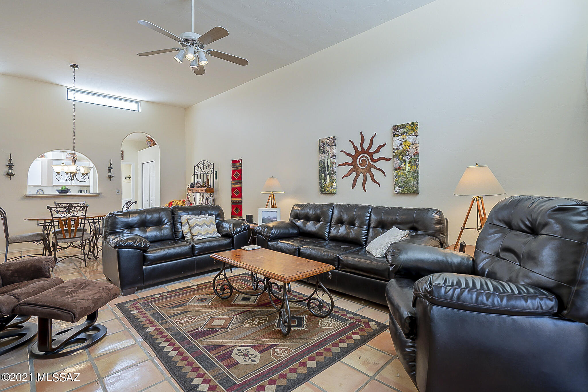 High ceilings, clerestory windows, an open floorplan are a few of the key features to this townhome built in 1994. Saltillo tile is found throughout except in the bedrooms. The breakfast nook looks out onto the gated front entry where gardenias and hibiscus flourish. Numerous skylights illuminate the interior. The rear patio borders a stretch of common area providing privacy. The laundry room and 2-car garage contain built-in cabinets, a utility sink, water softener. The HVAC unit was replaced in 2019.