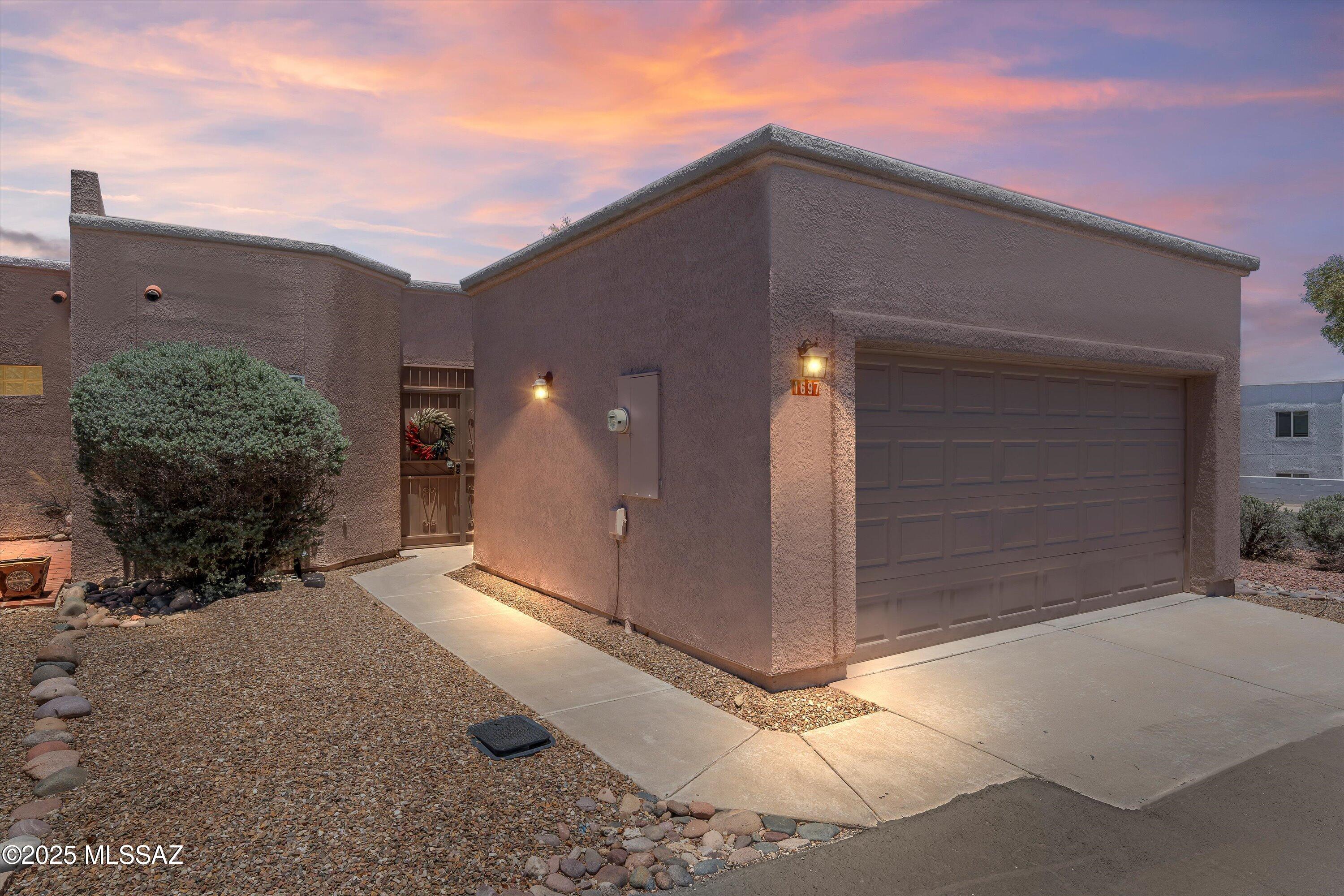 Welcome to your charming and updated corner townhome in the heart of Green Valley. This light-filled home offers a combination of privacy, space, and convenience—perfectly positioned with no shared side wall on one side, a nicely sized backyard with no immediate back neighbors, oversized coved patio, and plenty of nearby parking. A two-car garage adds even more value, making this home stand out in both functionality and price. Step inside to discover an open-concept floor plan with beautiful picture windows, neutrally colored vinyl flooring and a spacious den complete with an electric fireplace, ideal for relaxing or entertaining. The kitchen is efficiently designed and renovated with white cabinetry, granite counters, an over sink window, second dining space and a convenient laundry area just off to the side, while the extended, covered patio provides a peaceful retreat, perfect for enjoying morning coffee, evening barbecues, or a cozy space for pets.
Your new home is part of Green Valley Recreation, offering access to 14 premier recreation centers throughout the area with pools, fitness facilities, clubs, classes, and countless activities designed to enhance your lifestyle.
Ideally located near shopping, grocery stores, medical facilities, restaurants, golf courses, and more, this delightful home combines comfort, location, and affordability in one of Southern Arizona's most welcoming communities.