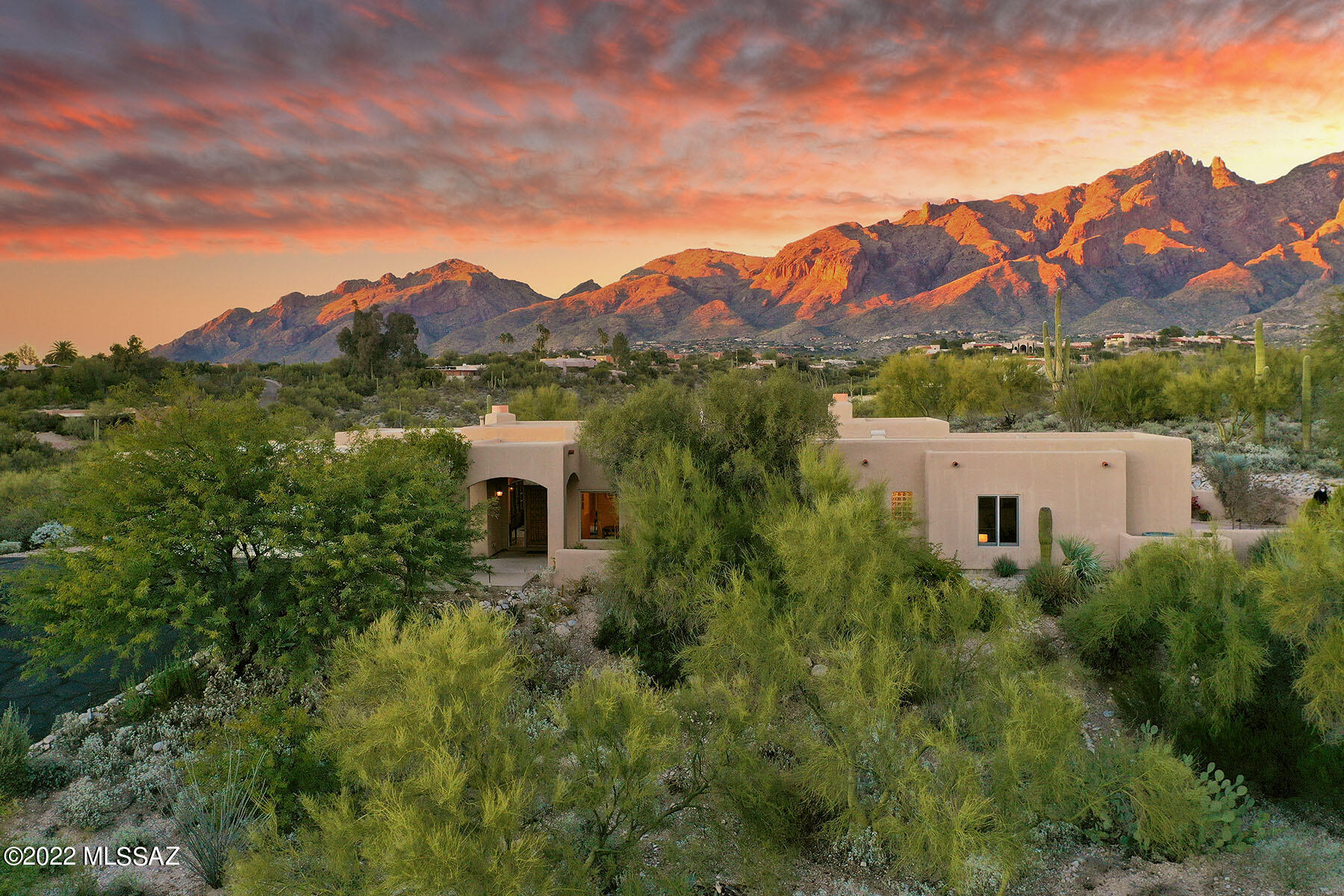 Perfectly located in the Catalina foothills, within a gated community and perched on a hill in a cul-de-sac.  This charming home has courtyard  entry w/ fountain & city light views.  This  lovely 4 bedroom 3 full bathroom home enjoys  12'ceilings throughout. Newer, Anderson, dual pane, wood-encased windows, surround sound throughout, Living room with a large picture window framing the  beautiful Santa Catalina Mt views. Separate Family room with a fireplace, Formal dining room area, Large eat in kitchen, with tons of storage SS appliances, The Primary bedroom has a fireplace, ensuite bathroom with a walk in closet and private patio.  Backyard has a patio w/flagstone,.  Extra large 3 car garage w/ tons of storage space.