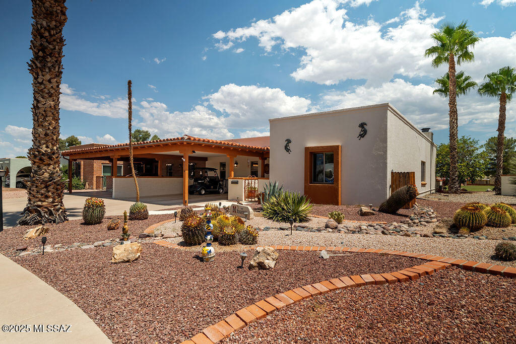 If tranquility, mountain and golf course views are on your wish list, this home is the one! Envision creating your favorite meals and having great experiences in the beautiful kitchen during your gatherings. The inviting living room has a fireplace and charming beams, creating a warm and cozy atmosphere. Both generously sized bedrooms offer you a sanctuary to relax and rejuvenate for your next day. Step outside to the spacious covered patio-imagine all the time you'll spend there savoring the scenery and Arizona weather with friends and family creating wonderful memories. The 2 sheds on the patio can be used to store tools to create your dream garden, to store your bikes and other fun items for your entertainment activities. Come see all that Green Valley has to offer! No GVR but avail.