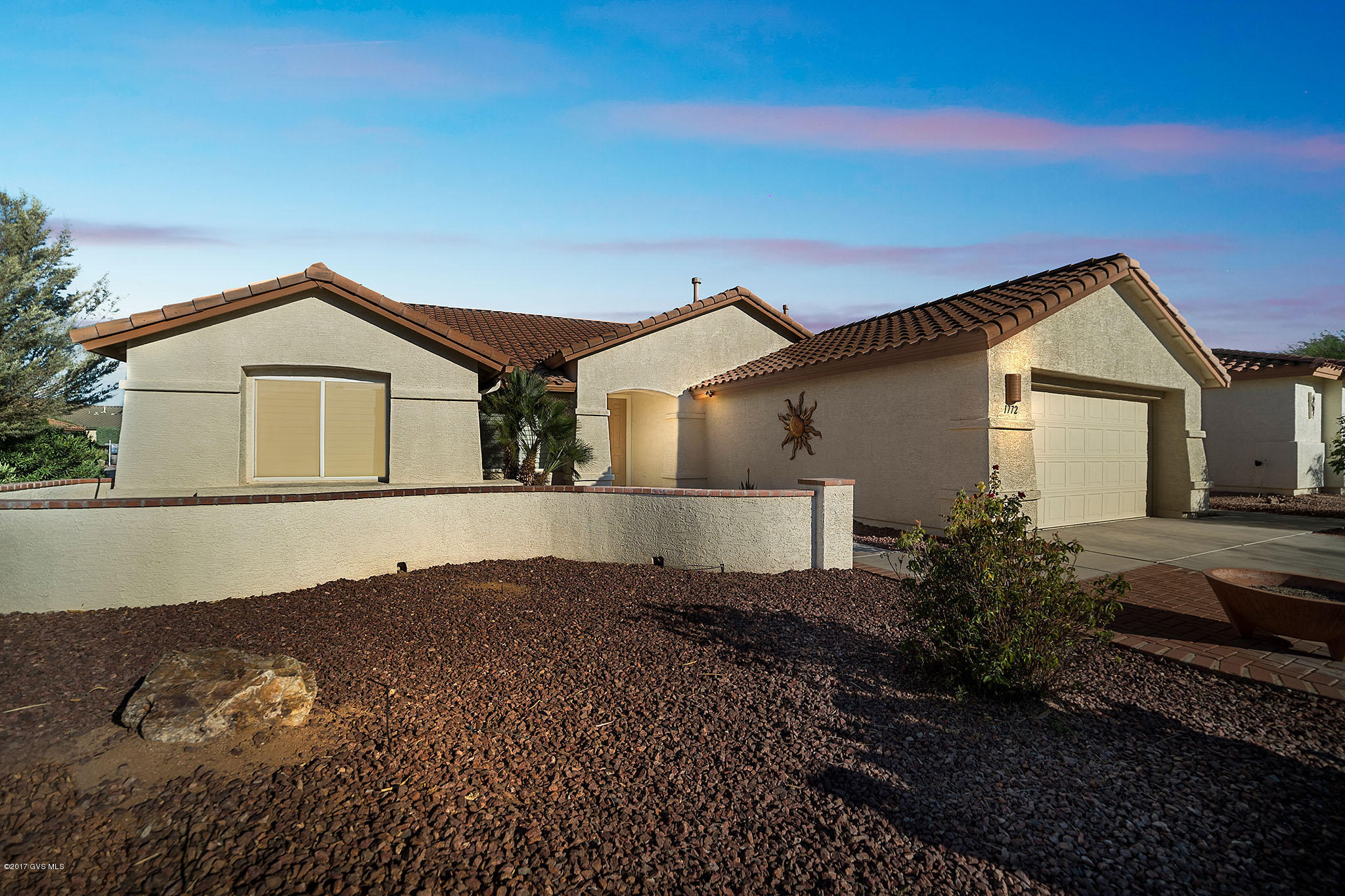 Situated on a large corner lot in the gated community of Quail Creek, this home is immaculate! Step inside and you will notice the gorgeous oversized tile that flows from room to room. The Cathedral height ceilings and wall of windows drench the living room, dining area and family room and kitchen in natural light. Enjoy watching your favorite movie or sporting events on the large screen TV with electric fireplace console in the family room. Your snacks can be waiting in the adjoining kitchen where you'll find an efficient layout for meal preparation and entertaining. A great kitchen with rich speckled granite countertops and full backsplash, black appliances and large pantry closet. Enjoy everyday meals is the peaceful eating nook encapsulated by bay windows with sharp  plantation shutters. An expansive master bedroom gives you a peaceful sitting area while dual sinks and a clear glass shower enclosure embellish your master bath. A quiet den gives you breathing room to escape and catch-up on some computer work or just relax with a novel. Continue out to your backyard oasis where you can relax on the shady patio with rolldown shades and built in grill. Or move out to the expanded flagstone decking surrounding the custom designed swimming pool and spa with waterfall while swaying palm trees surround you!