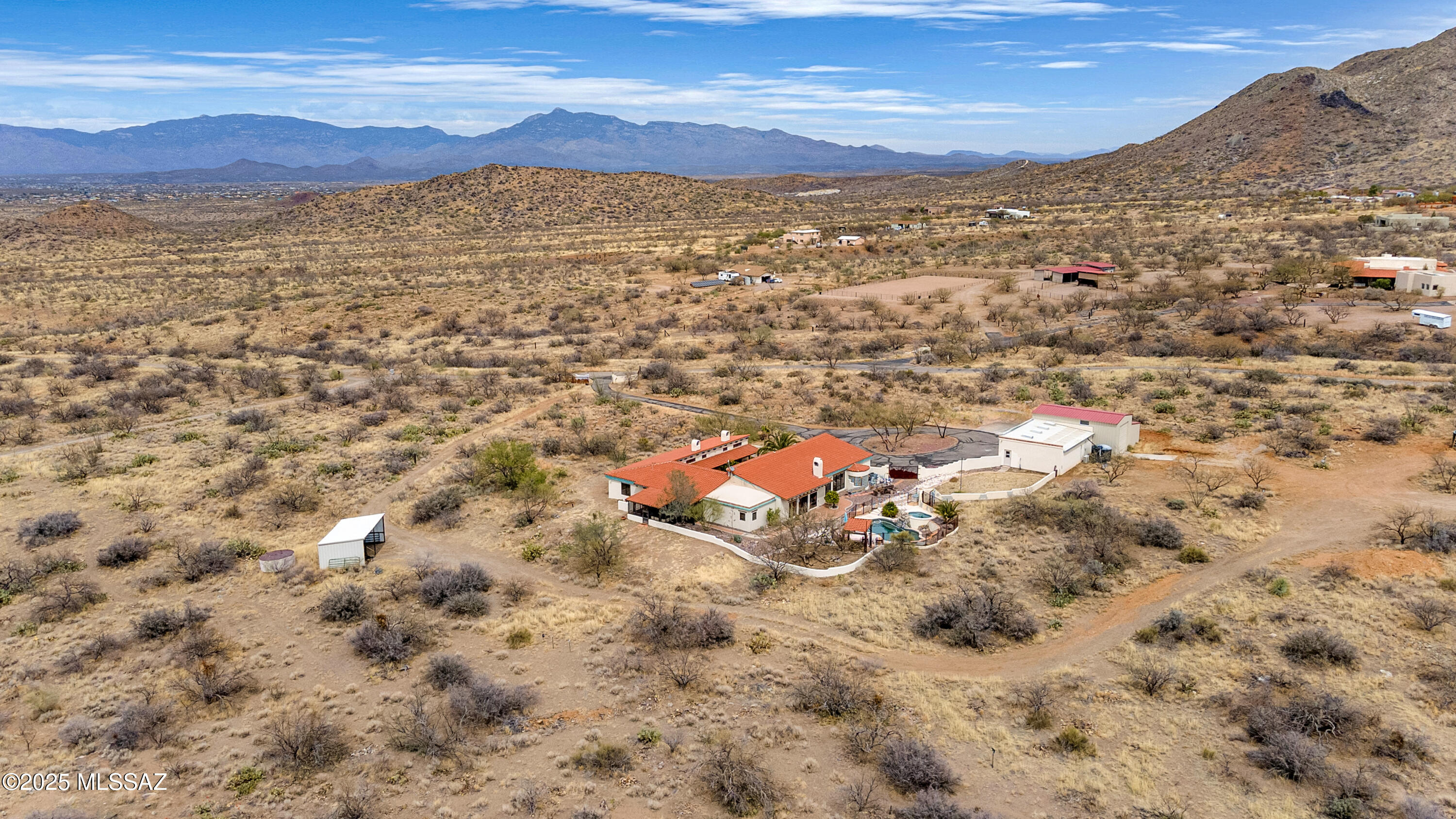 Beautiful custom built Rastra Block courtyard style home on over five fenced acres at 4000 feet elevation in the Santa Rita Mountain foothills. Built by the owner in 2002 with fabulous mountain views. Four bedroom, two and 1/2 bathroom, open kitchen to greatroom with high wood and Viga pole ceilings. Kitchen with concrete counter tops, Mesquite cabinets with Saguaro ribs, Saltillo tile throughout. 10'' thick walls with R-41 insulation value. 400 amp electrical service, horse property with loafing shed, metal gated, paved driveway, RV garage drive-through with 50 amp electrical service, three car garage, two with copper look doors, insulated with mini-split heat pump, 12' X 26' shop inside garage, swimming pool, four kiva fireplaces, Arizona room with grill and mini refrigerator, clay tile roof. Metal clad, wood framed windows, Solid Mesquite and Alder interior doors, custom brick inlay dome over 15' X 20' kitchen. Hauled water. 480' deep dry well on sight.