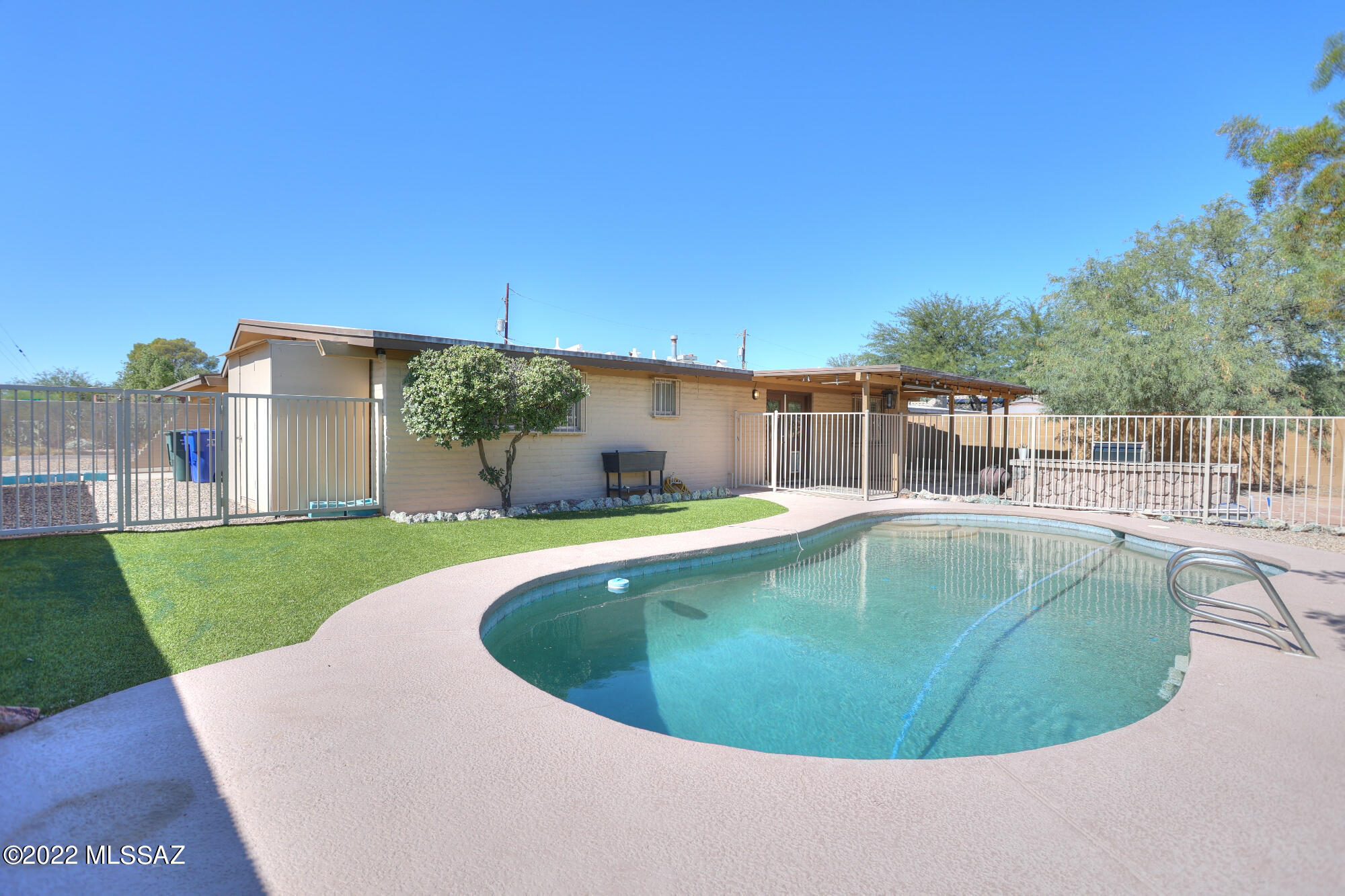 You will not want to miss out on this central property located right off the Campbell corridor. As you enter you will see the large entertaining room off of the spacious kitchen. Newer wood look tile throughout with carpet in the bedrooms. Upgrades include new A/C and furnace (2021), pool sand filter (2022) and privacy blinds. Plantation style shutters throughout as well as large picture windows. The backyard boasts a large covered patio, flagstone hardtop with built in BBQ as well as a Pebble Tec pool surrounded by turf. There is also a dedicated storage room and a shed. Circular concrete driveway with pass thru 2-car carport is perfect for entertaining.