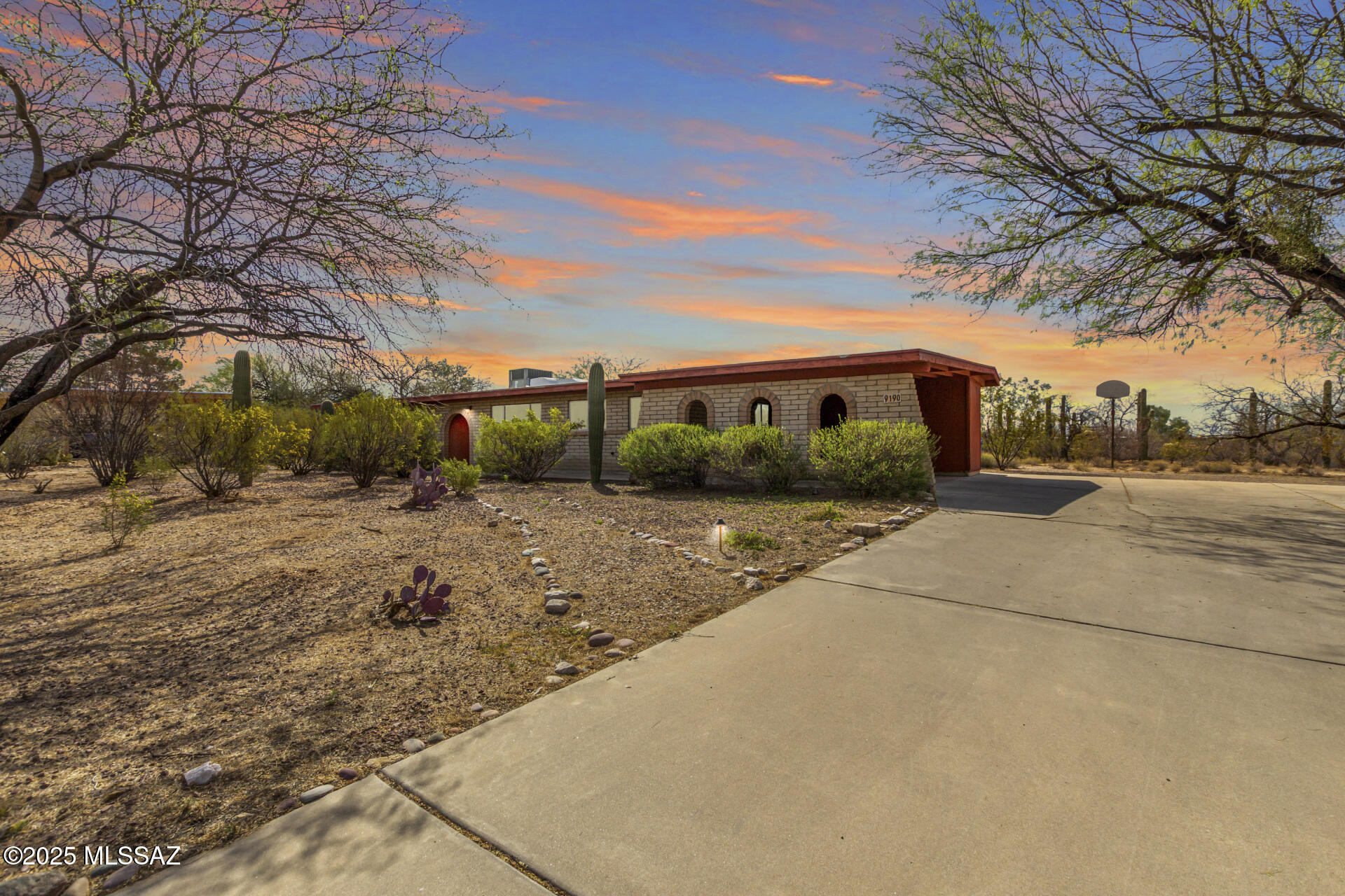 Set against the serene backdrop of Tanque Verde Valley, this stunning single-family home, never before on the market, offers nearly an acre of private land (.96 acres) with sweeping views of Bear Canyon. The property is a sanctuary, surrounded by nature, with birds soaring and the soothing sounds of the desert all around. Inside, you'll find an updated kitchen w/ quartzite countertops, Rojo's scored concrete floors, ample natural light, and open, airy spaces. Recent upgrades include a 2022 Trane 14 SEER heating/cooling package unit (with a 10-year warranty), a new 2024 water heater, new interior paint, new carpets, and updates bathrooms, including new tile. This well-loved, well-maintained home is ready for a new owner who will appreciate the serenity and beauty of this special location. Nature lovers only! It's one of the largest lots in the neighborhood, with an impressive array of saguaros. Also, a good location for growing as well, if you have a green thumb.