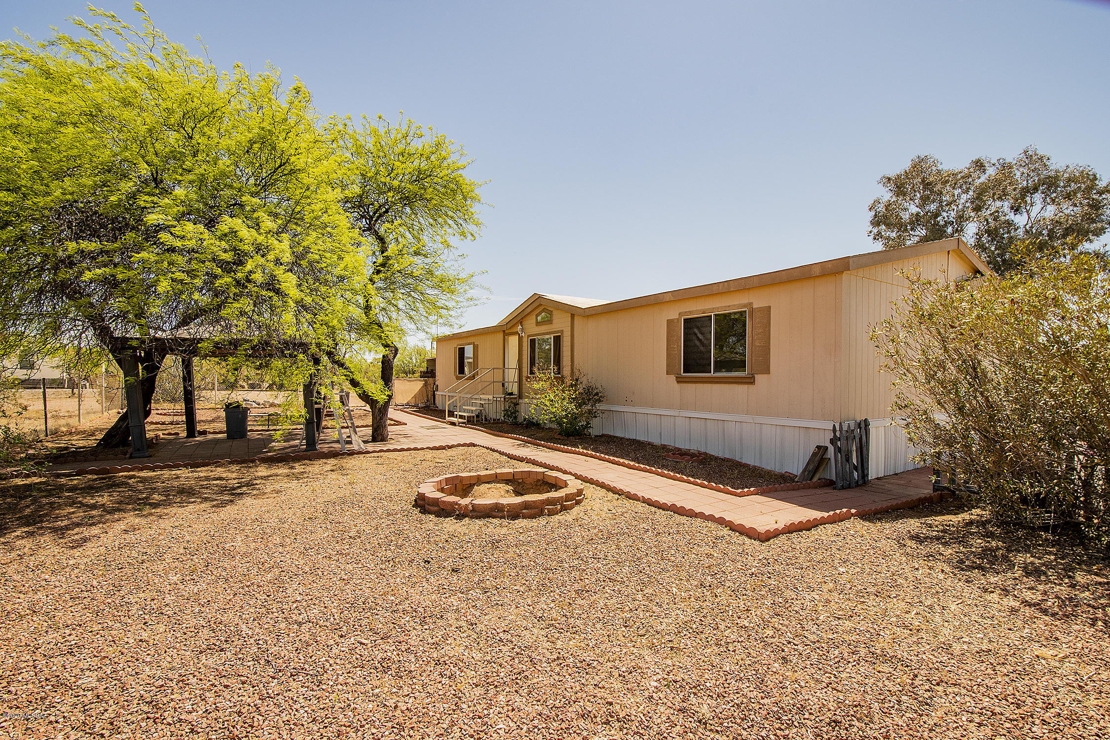 Beautiful home available on 1.09 acres of zoned horse property in west Tucson located off a paved road. This property gives you Privacy, lots of storage, fully usable lot, and great mountain views. The home offers you 3 large bedrooms with walk in closet plus 2 baths. The floorplan is spacious and open with high vaulted ceilings. Large windows allowing for an abundance of natural light to flow through. Brand new neutral carpet throughout. Big open kitchen with walk in pantry. Take your choice of both large formal and family room to relax in. Master retreat includes a private en-suite with separate soaking tub and shower. Split floor plan allows for space and privacy. You will also love the convenience of the outdoor area being already fully fenced. Very accessible lot to bring all (cont) your toys with mature trees. Large rear covered decks offering great entertaining area and views. 40' container/shop with electricity/storage unit stays.