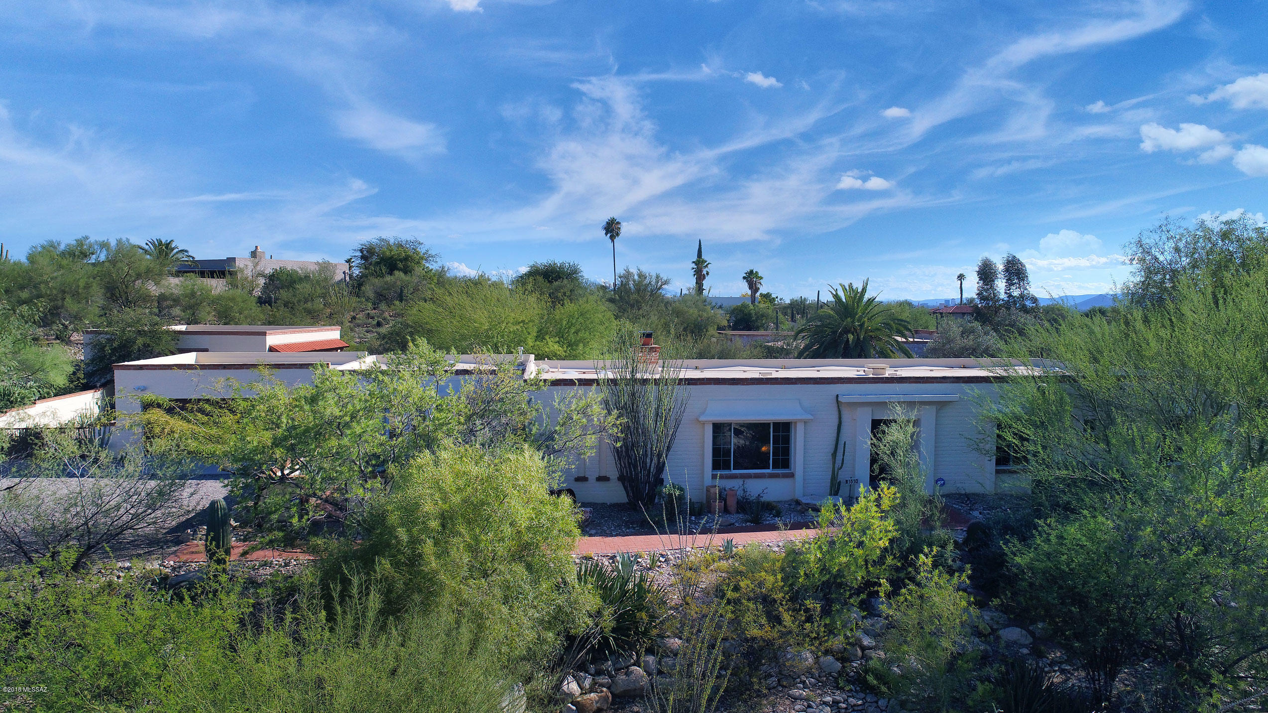 Nestled on a quiet cul de sac lot this charming and comfortable territorial is loaded with Old Tucson character & provides a peaceful private oasis.  The floor plan flows wonderfully for accommodating large or small gatherings.. French doors open onto patios from family room, master and guest room bringing the outside in.  The  remodeled kitchen is the heart of the home and features world renowned La Cournue gourmet stove/oven, beautiful corian counters, oak cabinets , stainless appliances. 
The back yard welcomes you with extended patio and multiple seating areas, a diving pool and shade trees.  If your a car enthusiast or in need of work space or storage, the detached building affords both.
This wonderful property within easy proximity to amenities is the perfect place to call home!