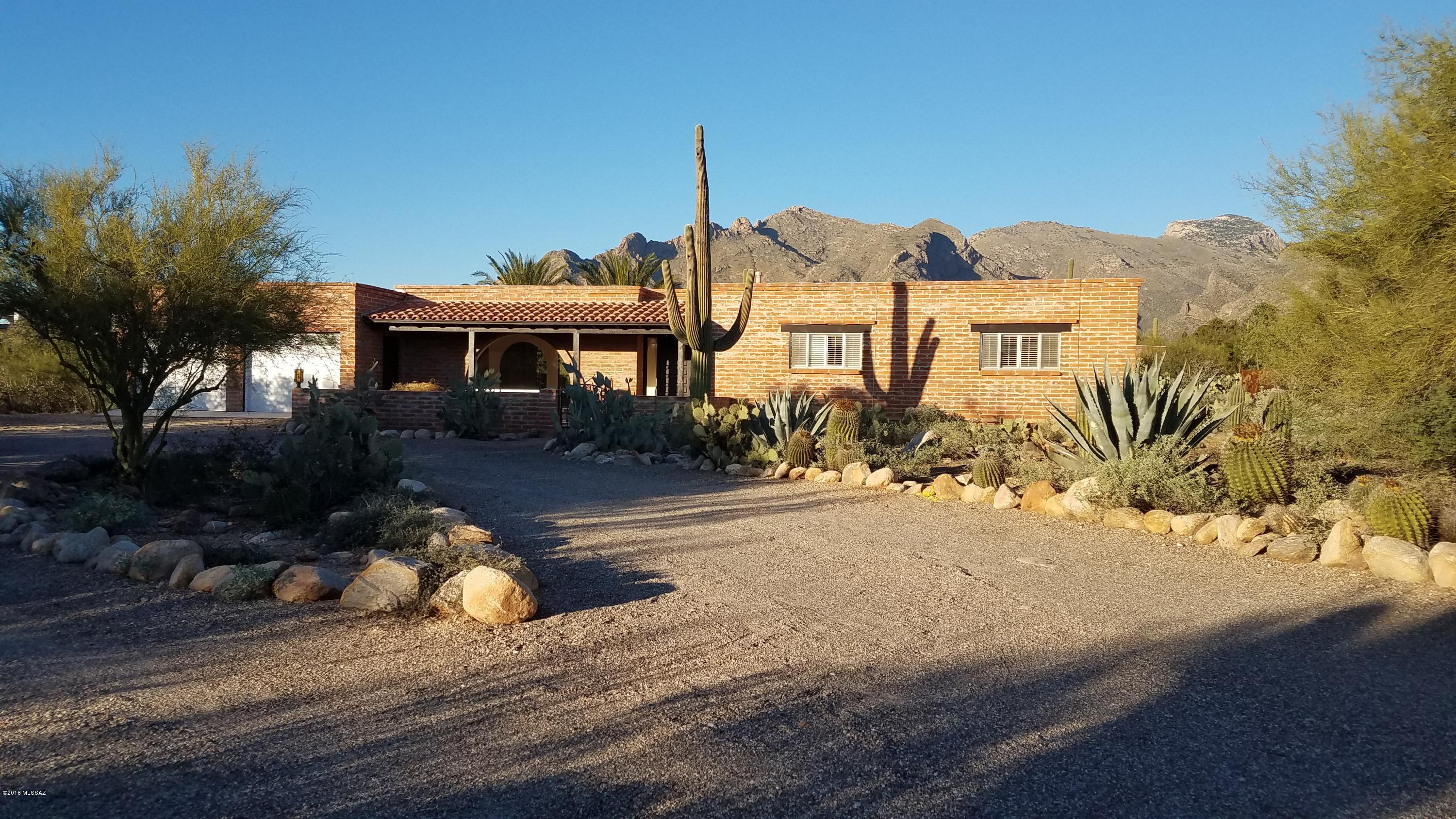 Wonderful 4 bedroom house with split floor plan. Two bedrooms with ensuite bathrooms. Living room, dining room, family room, and breakfast area. Views of the Catalina Mountains to north from most of the house. Large covered patios, private custom spool with gas heat and automation. Saltillo tile in main living areas with new carpets in all bedrooms.  House is located in a quiet area of the Foothills with no road noise.  Parking for large RV on site-no hookups.