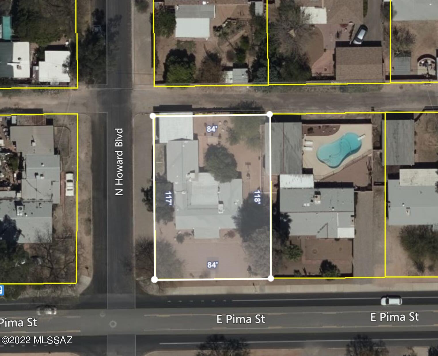 Location! Location! Location! Few minutes to U of A, Banner Hospital, Reid Park Zoo, and Downtown. New privacy/sound reduction wall out front. 1950s home with lots of character and charm. Beautiful brick construction. Exposed wood beams in AZ room. 3 bed 2 bath split bedroom plan. Tile floors throughout except laminate flooring in Master. Large Master bedroom.  Recently remodeled kitchen features: Floor to ceiling cabinets, gas stove, built-in microwave, recessed lighting, granite countertops with fancy backsplash. Spacious Laundry room. Lovely backyard with mountain views and covered patio and pavers. 2 car carport can easily be converted to a garage by adding a garage door. NO HOA